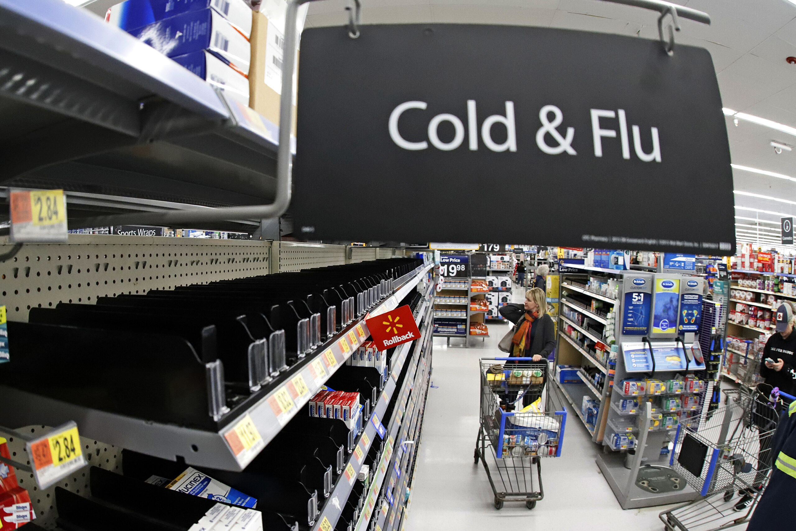 Woman peruses cold & flu section at Walmart