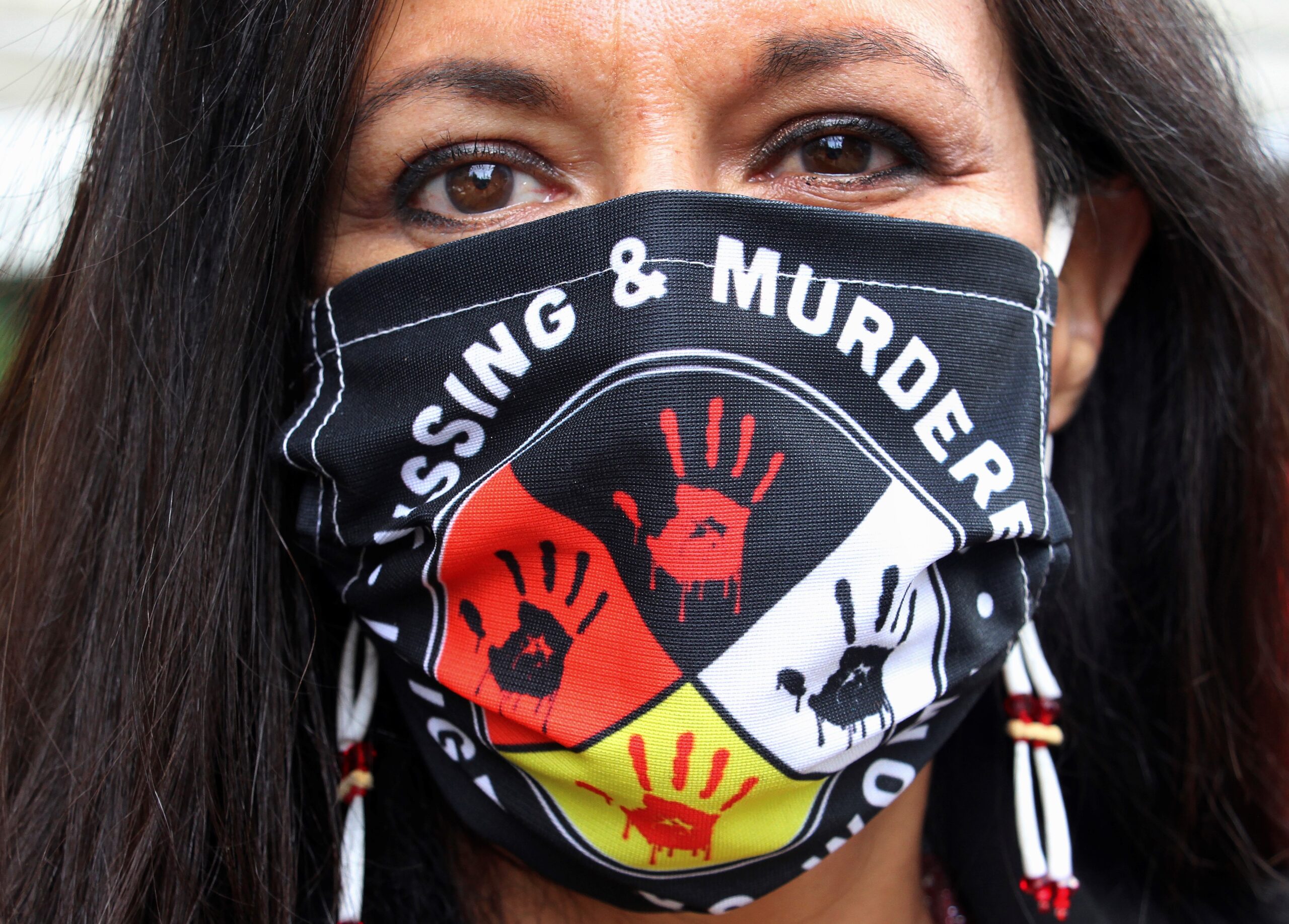 Jeannie Hovland poses with a Missing and Murdered Indigenous Women mask