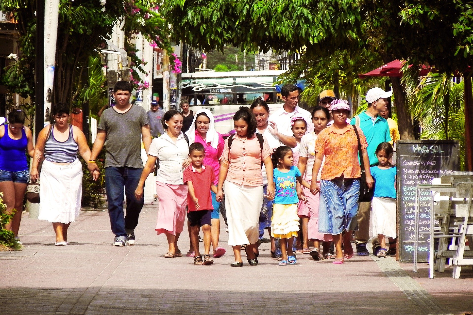 Latino family walking down a street.