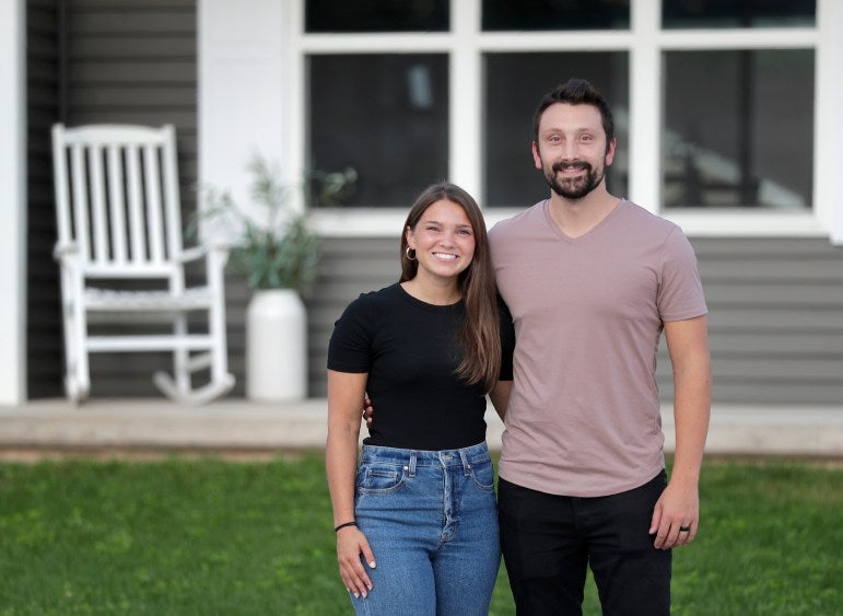 Amy and Erik Van Hammond appear in front of their home in Kaukauna