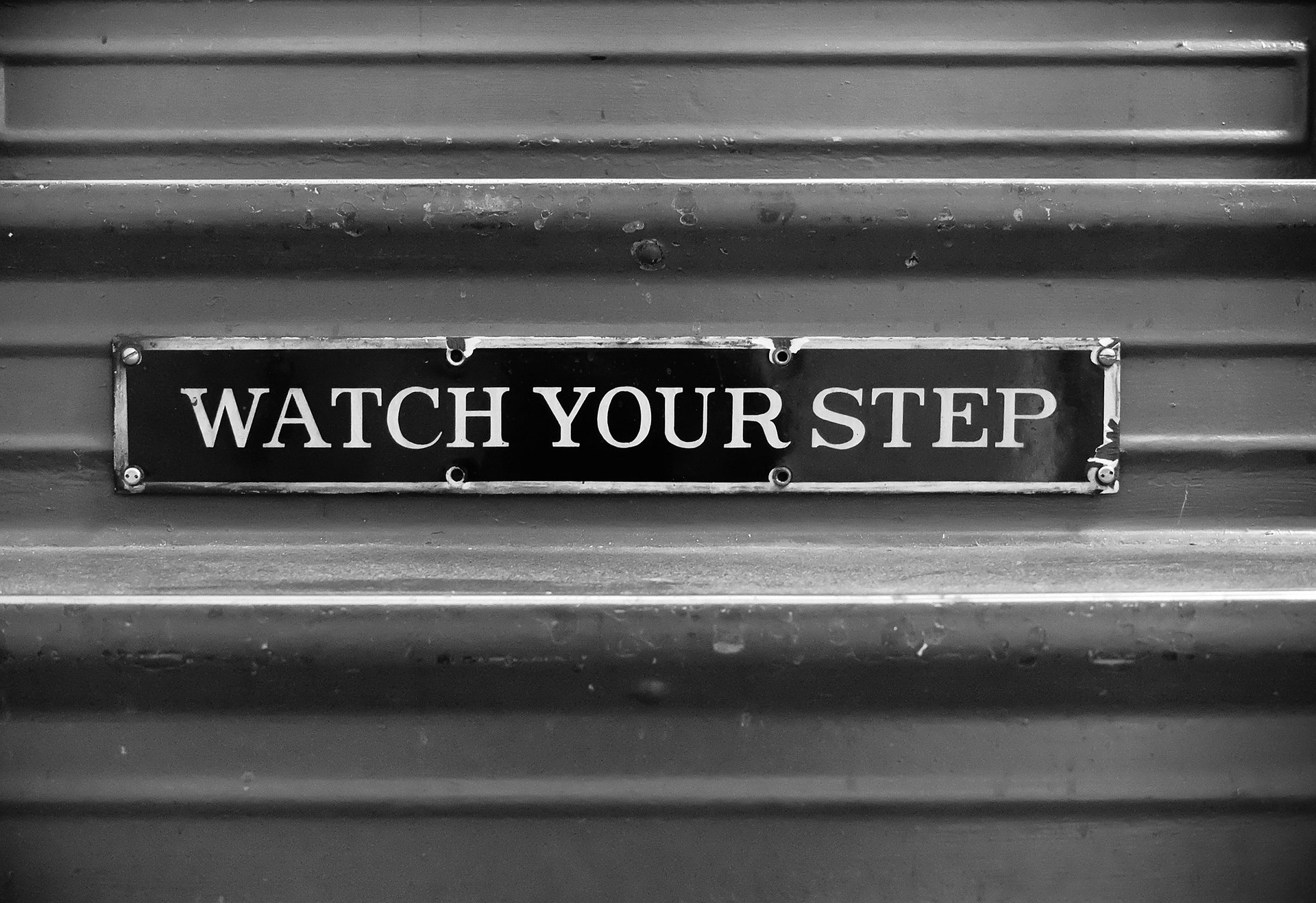 Watch Your Step sign on stairs.