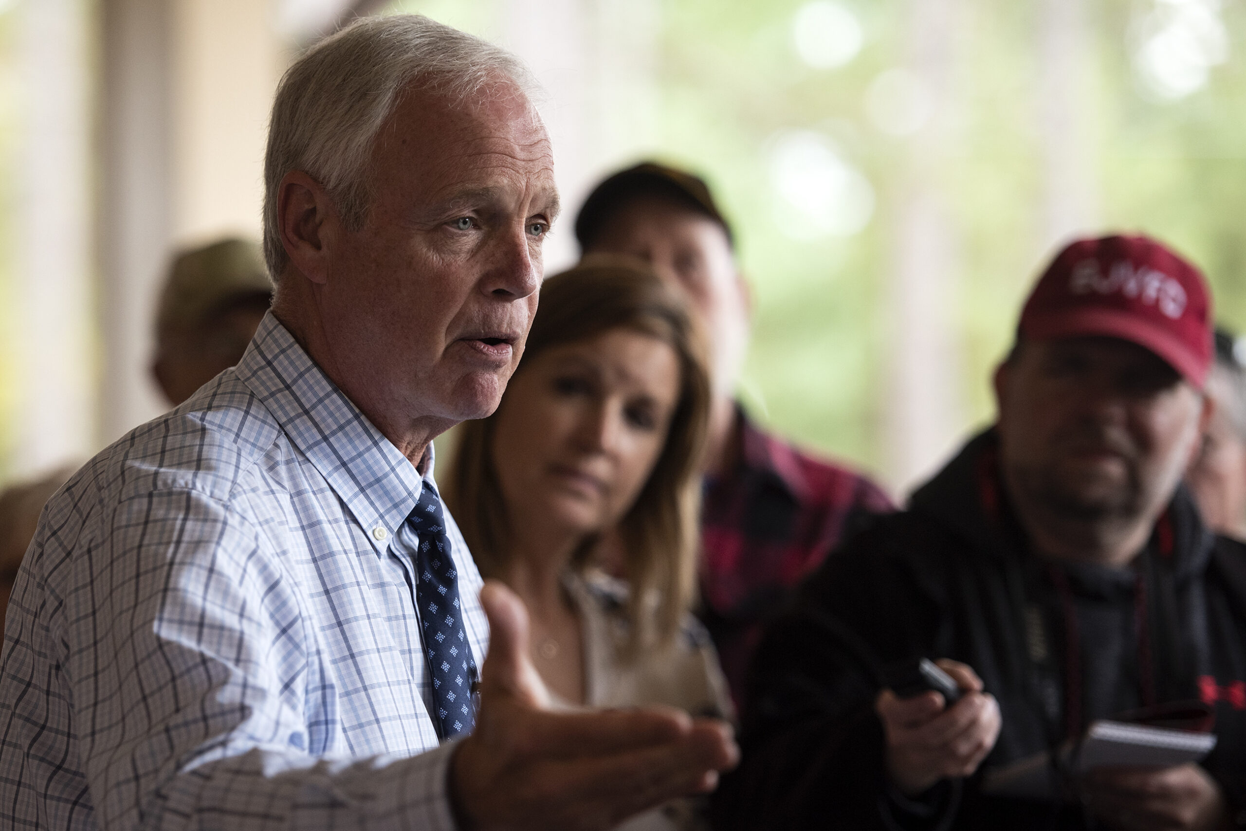Sen. Ron Johnson gestures as he speaks outside to reporters.