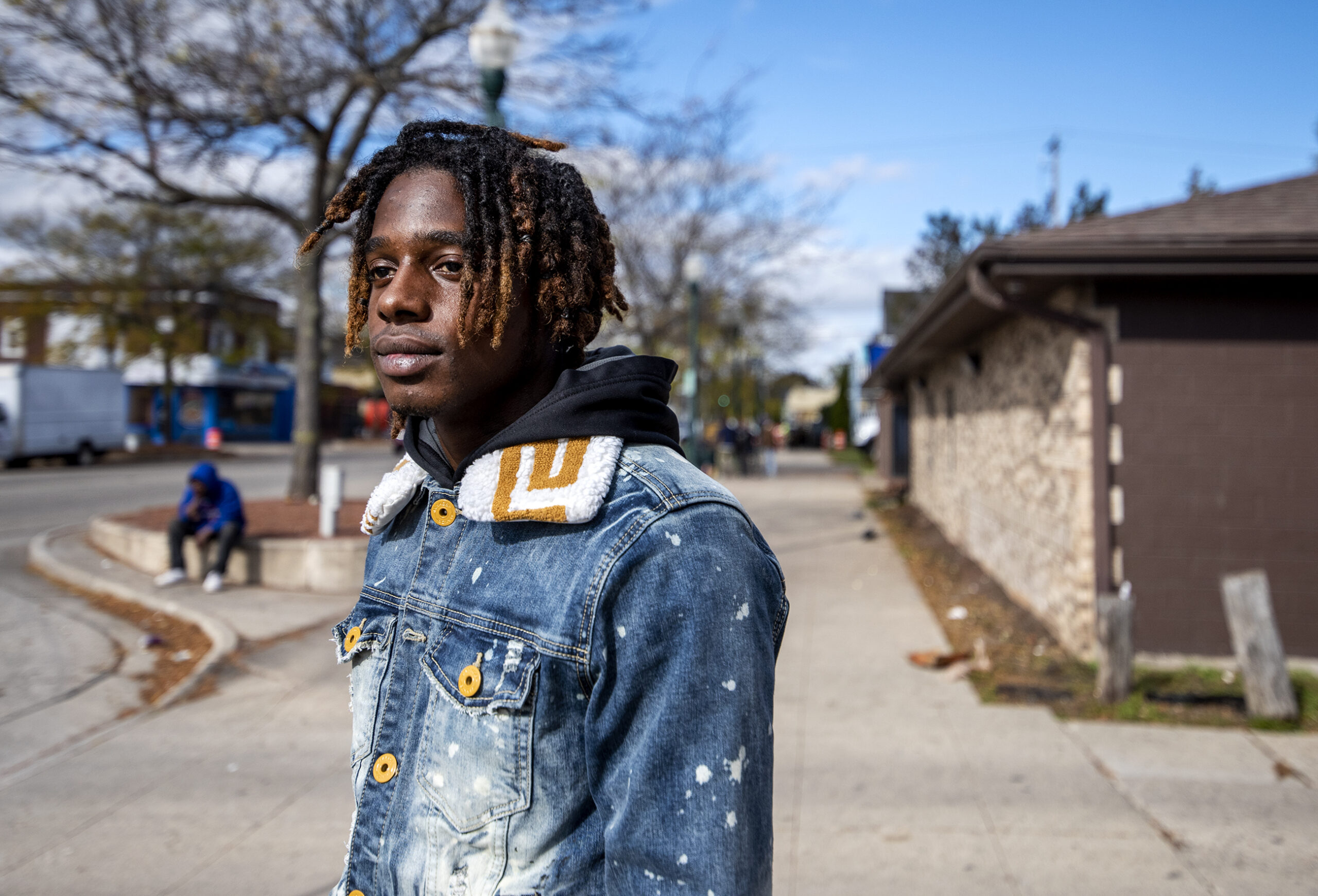 Dwayne Simpson wears a denim jacket as he stands outside on a sidewalk.