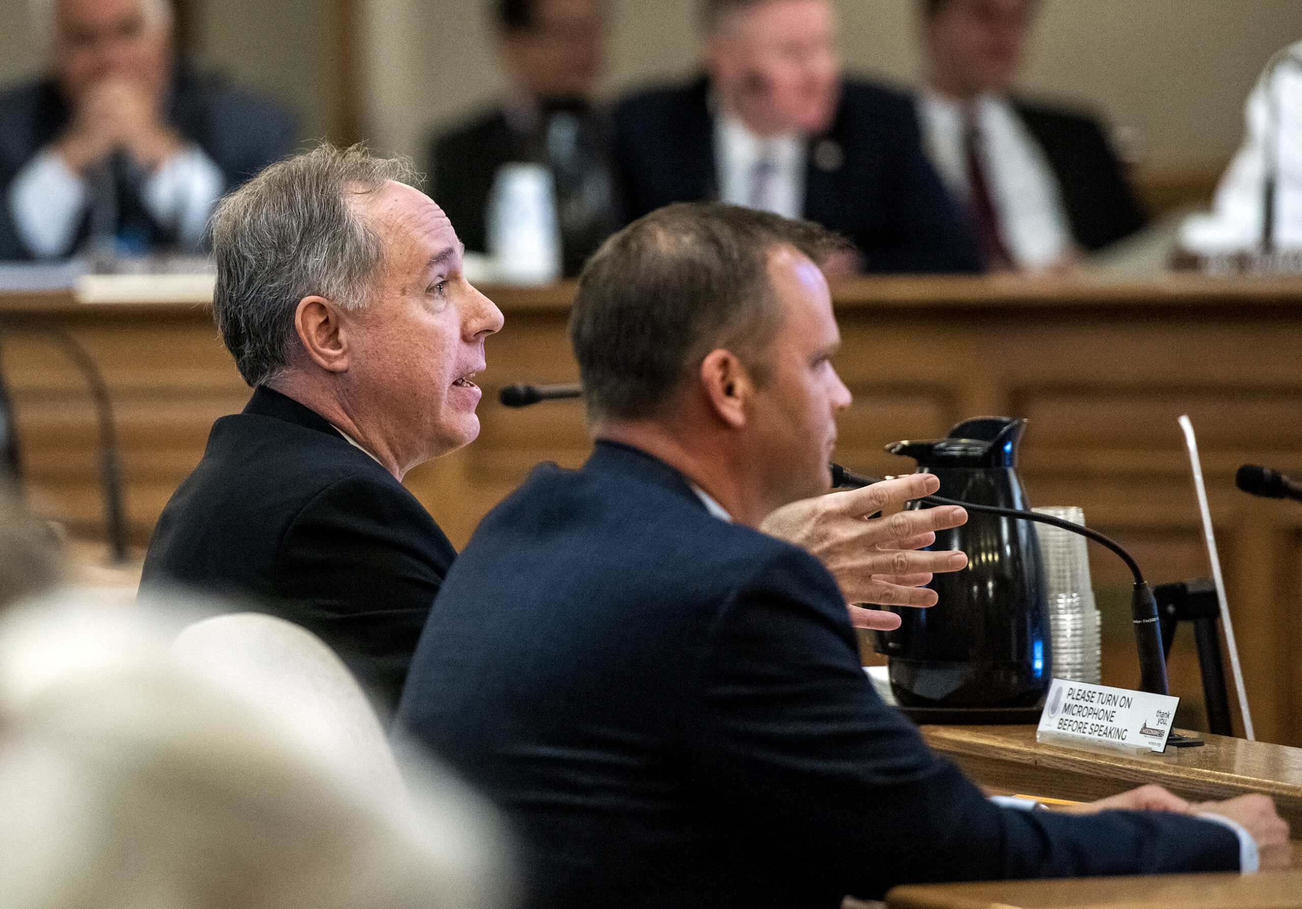 Wisconsin Assembly Speaker Robin Vos gestures as he speaks while seated in front of other state legislators.
