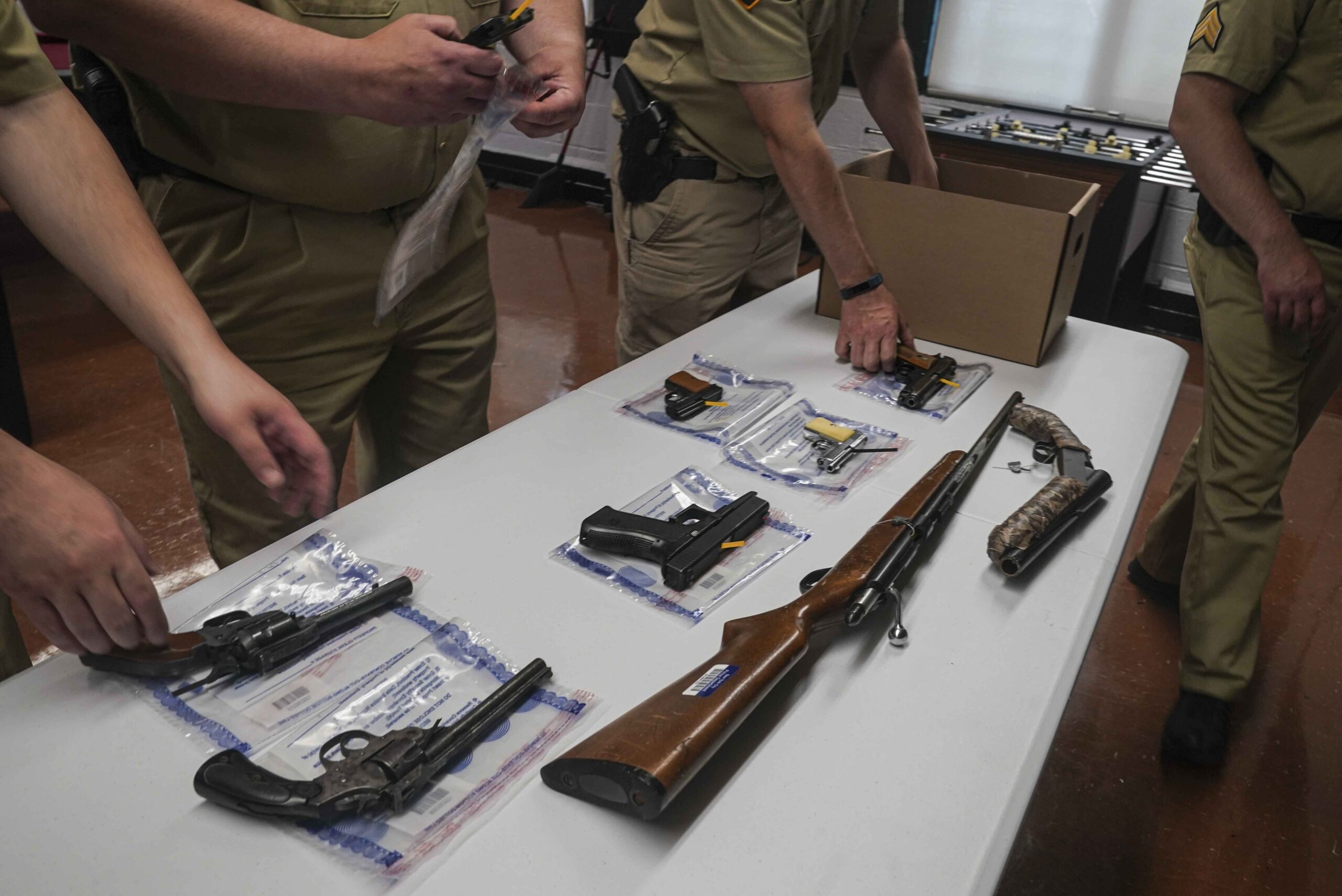 Police officers with firearms from a buyback program