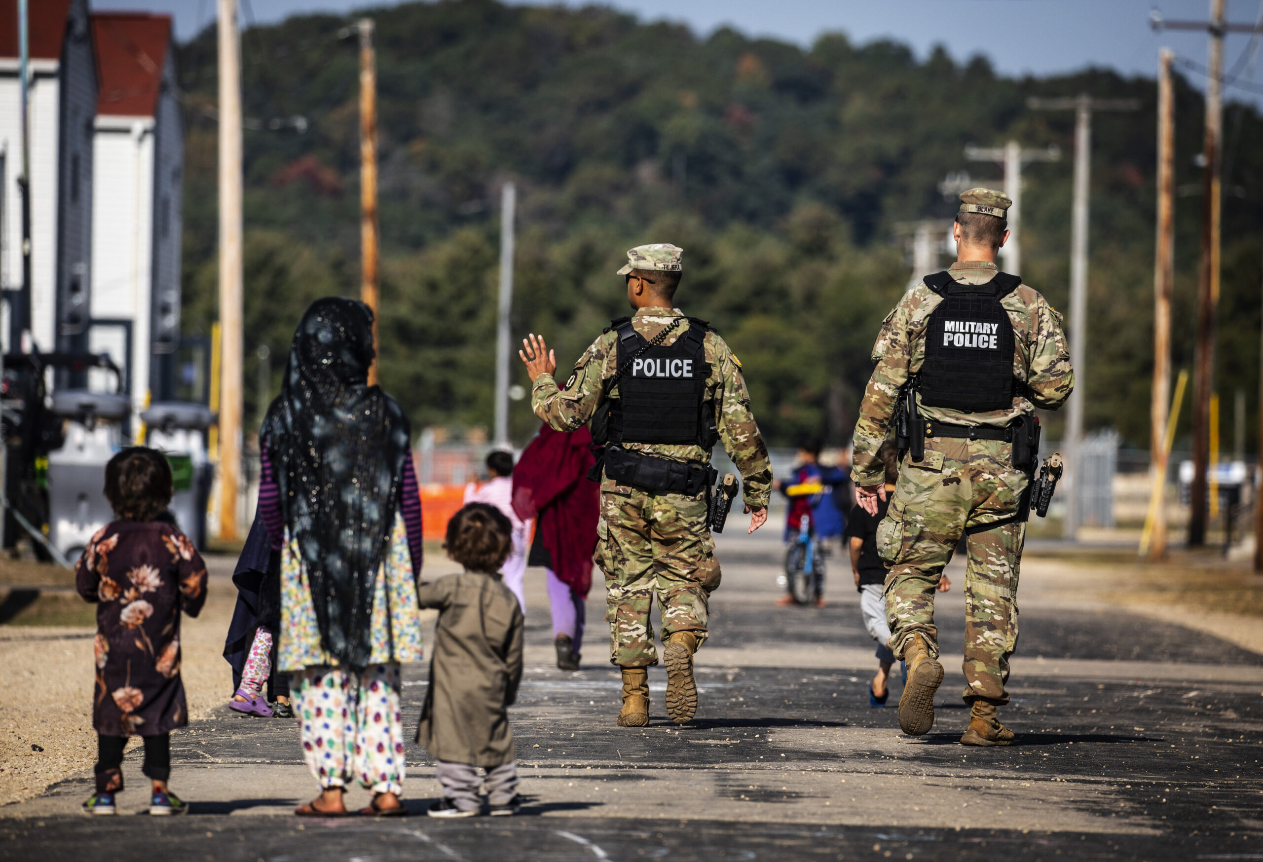 Military policy waving at Afghan refugees at Fort McCoy