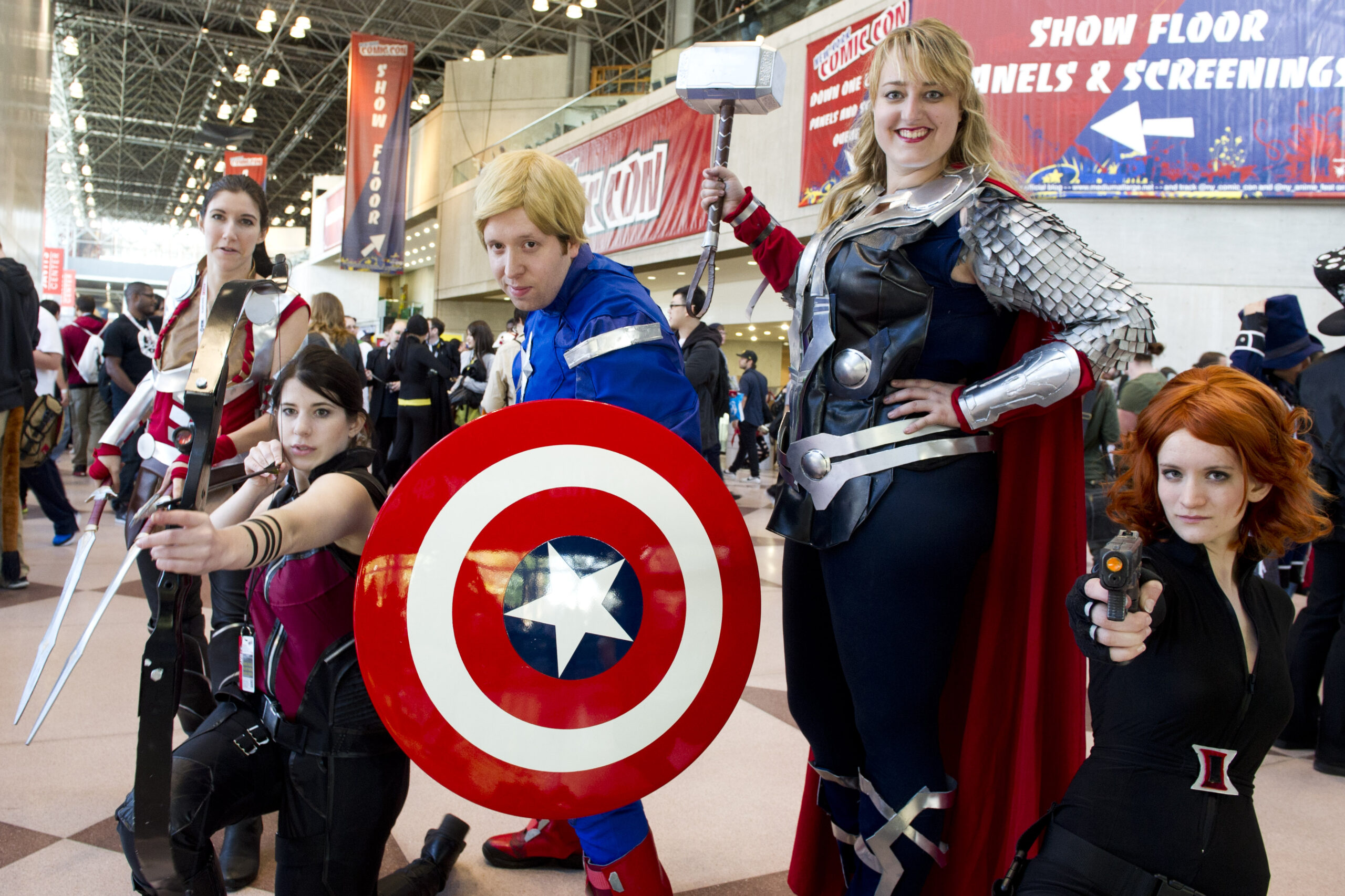 Male and female fans dressed as superheroes and comic book characters at Comic Con