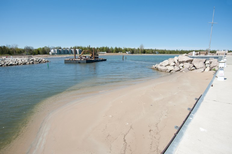 The Baileys Harbor Marina in Door County, Wis., as a barge dredges the channel
