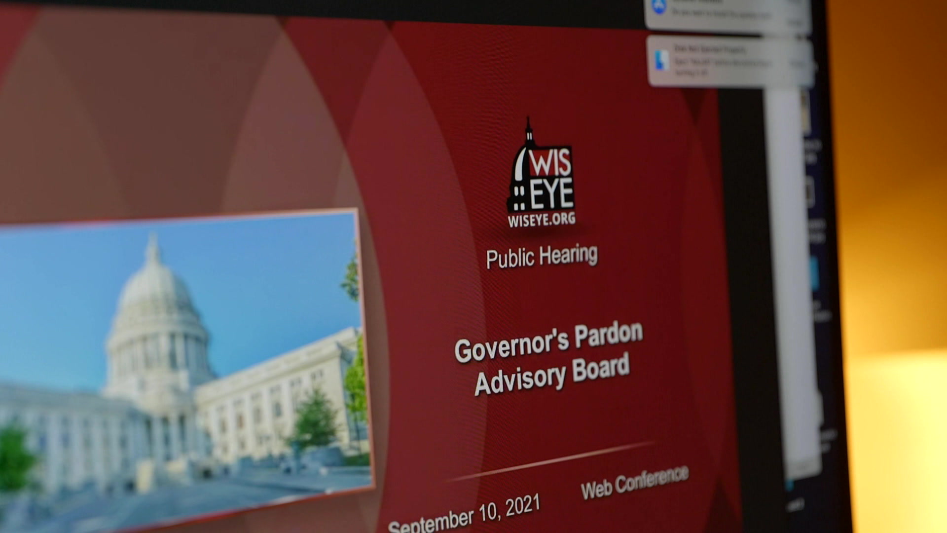 A compter shows the title screen for a WisEye presentation of a Governor's Pardon Advisory Board web conference.