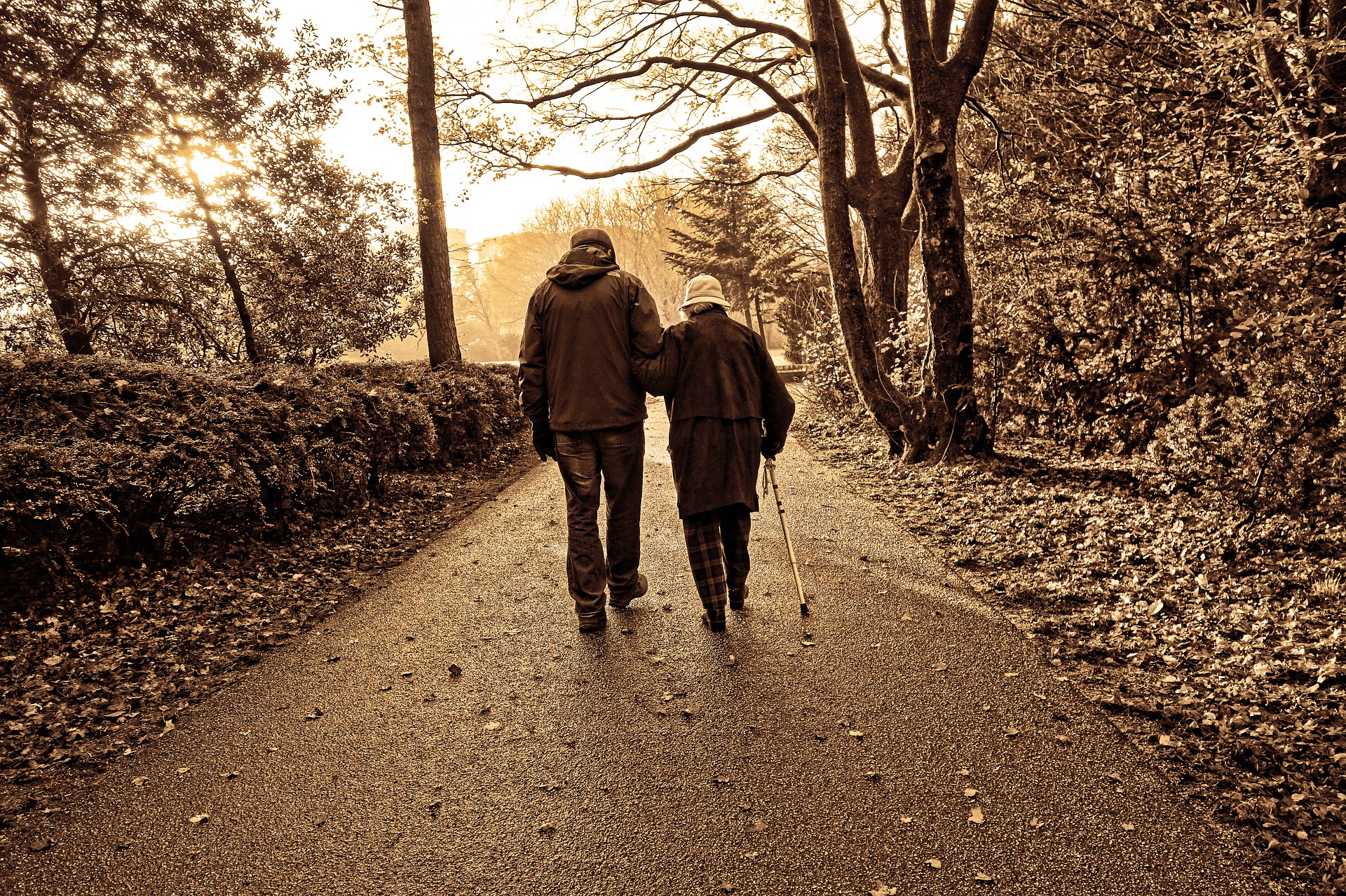 Older couple walking down road.