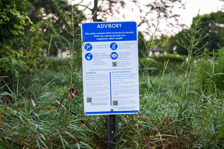 A sign warning of PFAS risks in Starkweather Creek