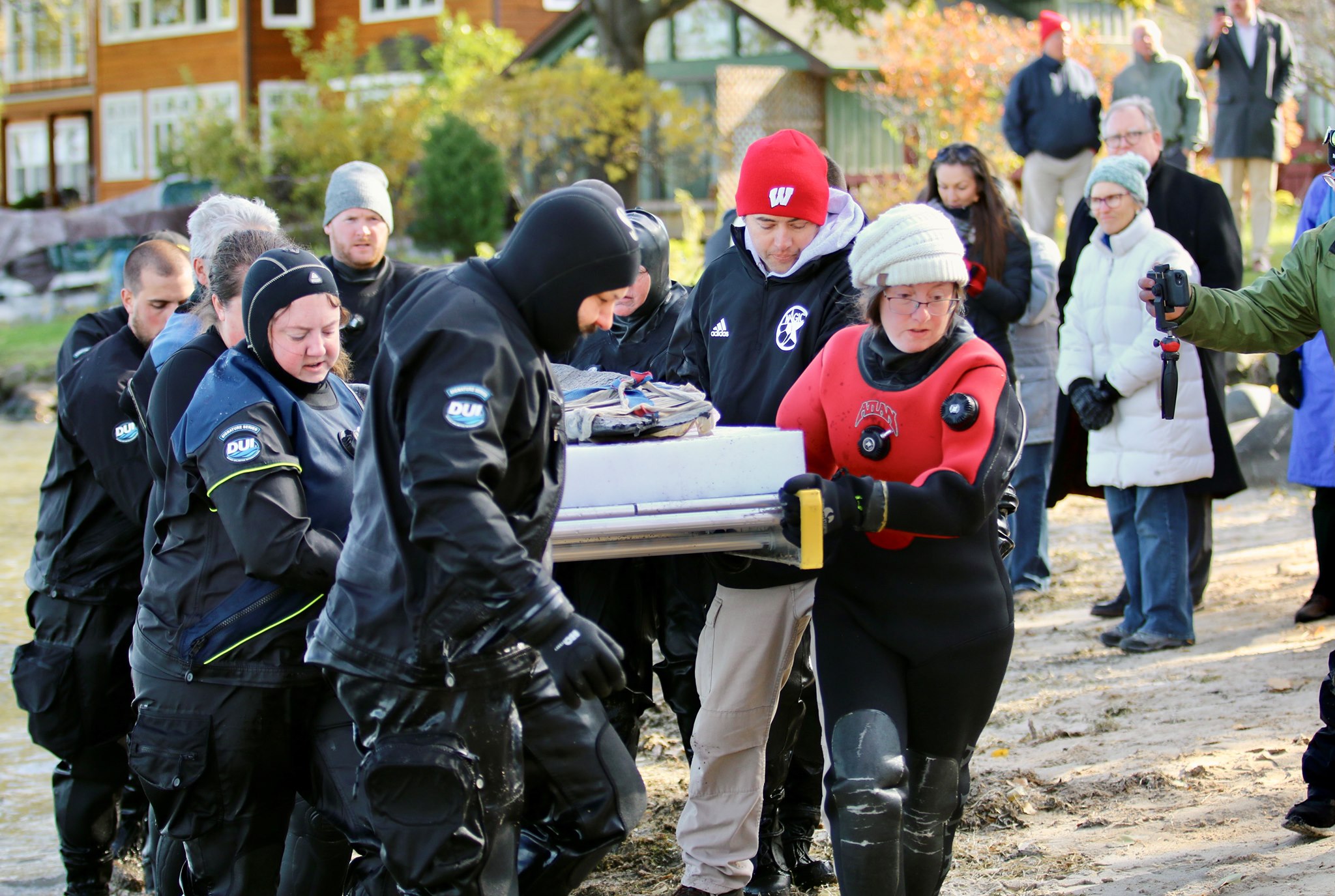 A 1,200-year-old canoe found in Lake Mendota is carried on a gurney for support after being recovered.