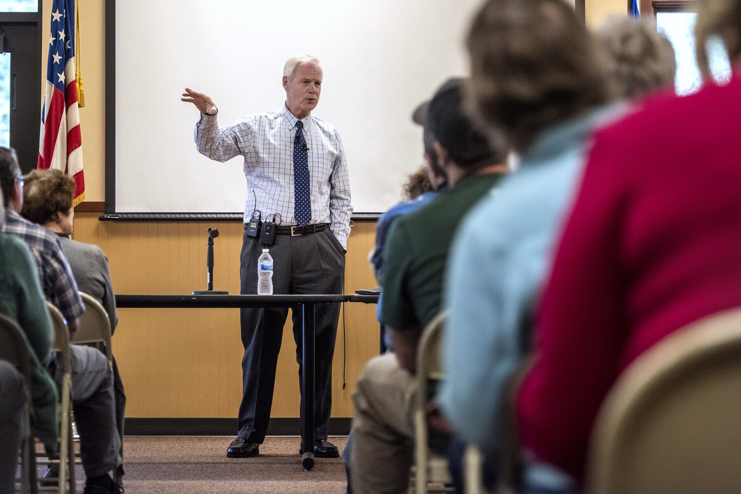 Sen. Ron Johnson gestures as he stands in front of a crowd of constituents.