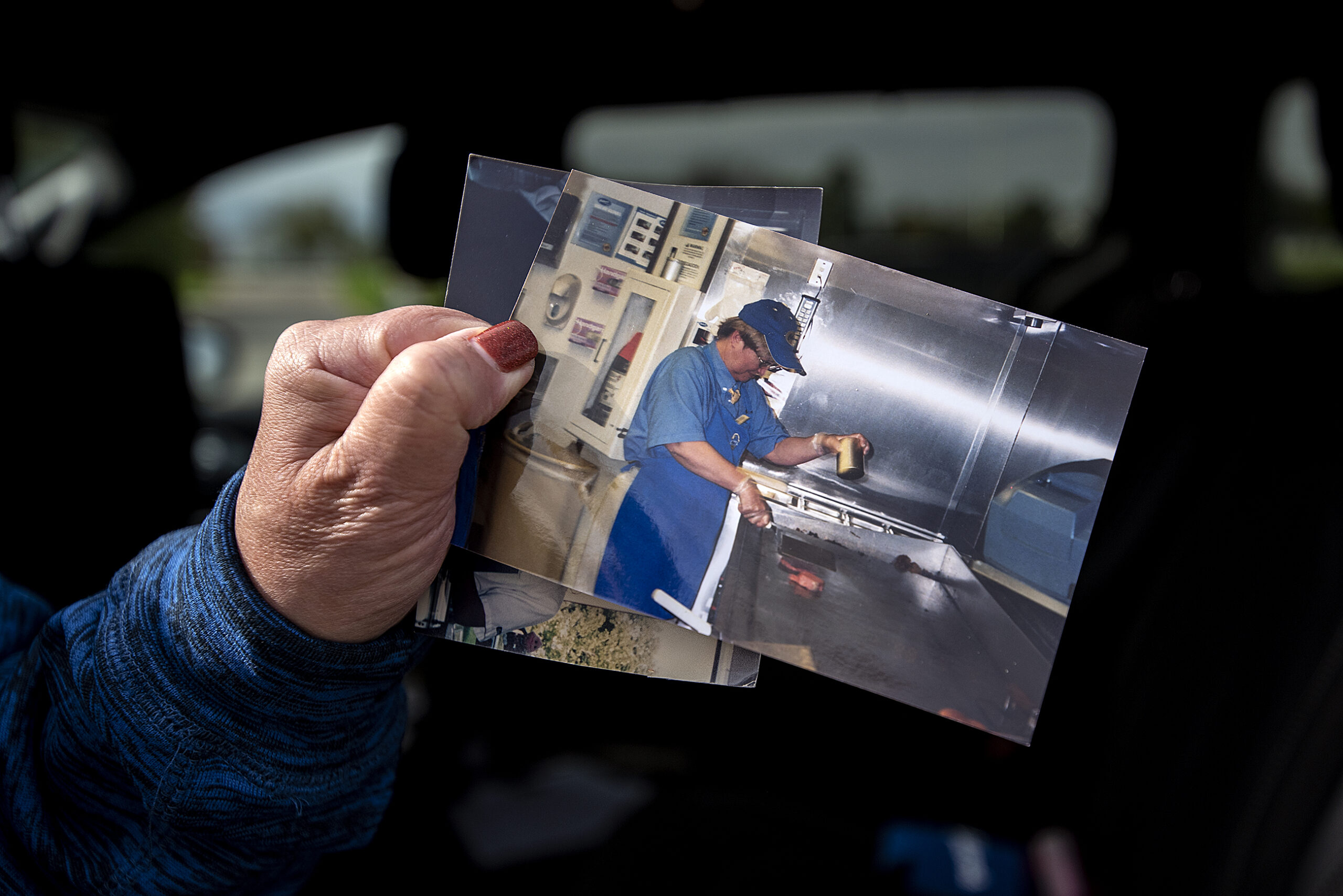 A printed out photo shows Rita Larsen working at a grill in a Culver's restaurant.