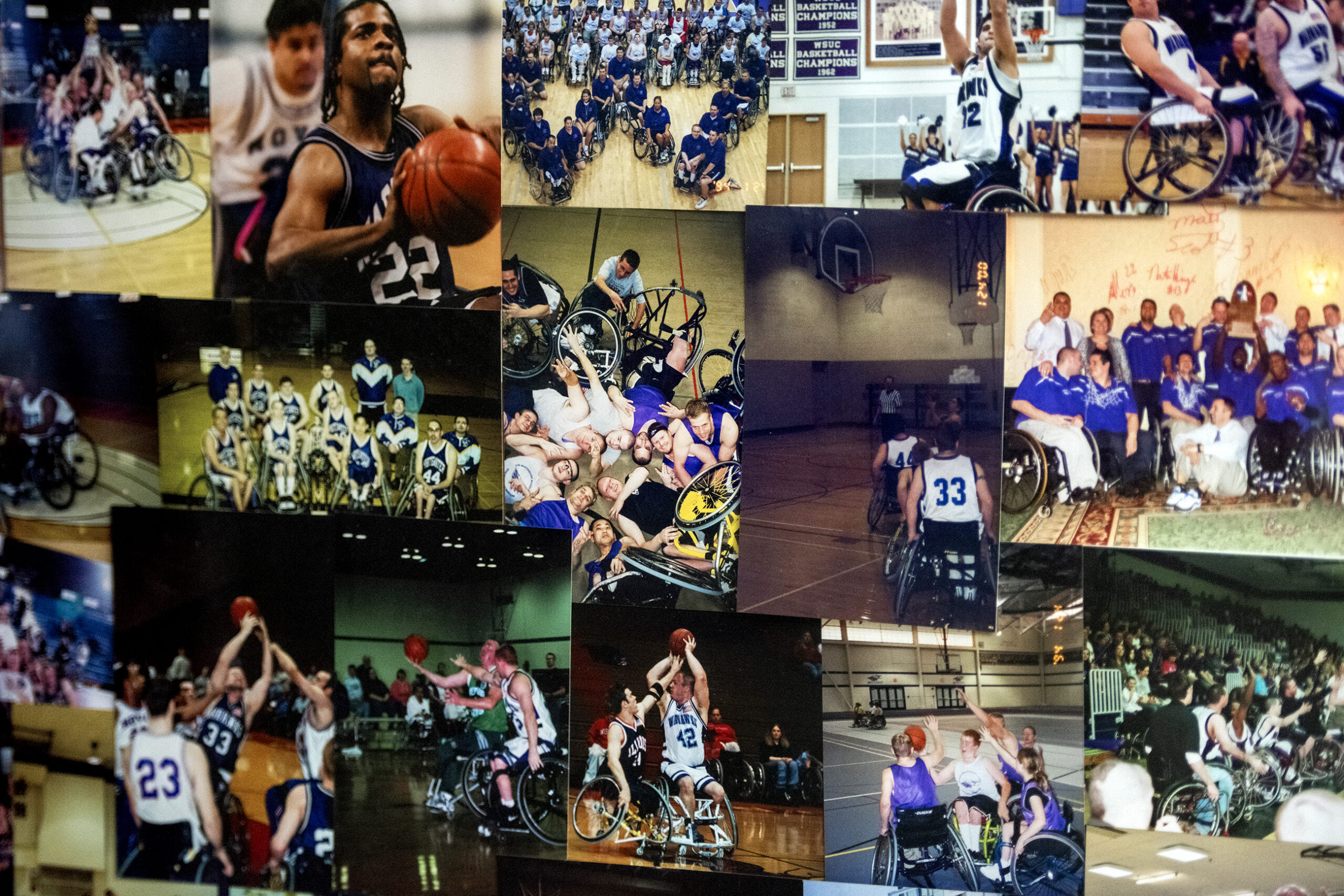 Printed photos showing basketball games and past teams are hung in a collage style.