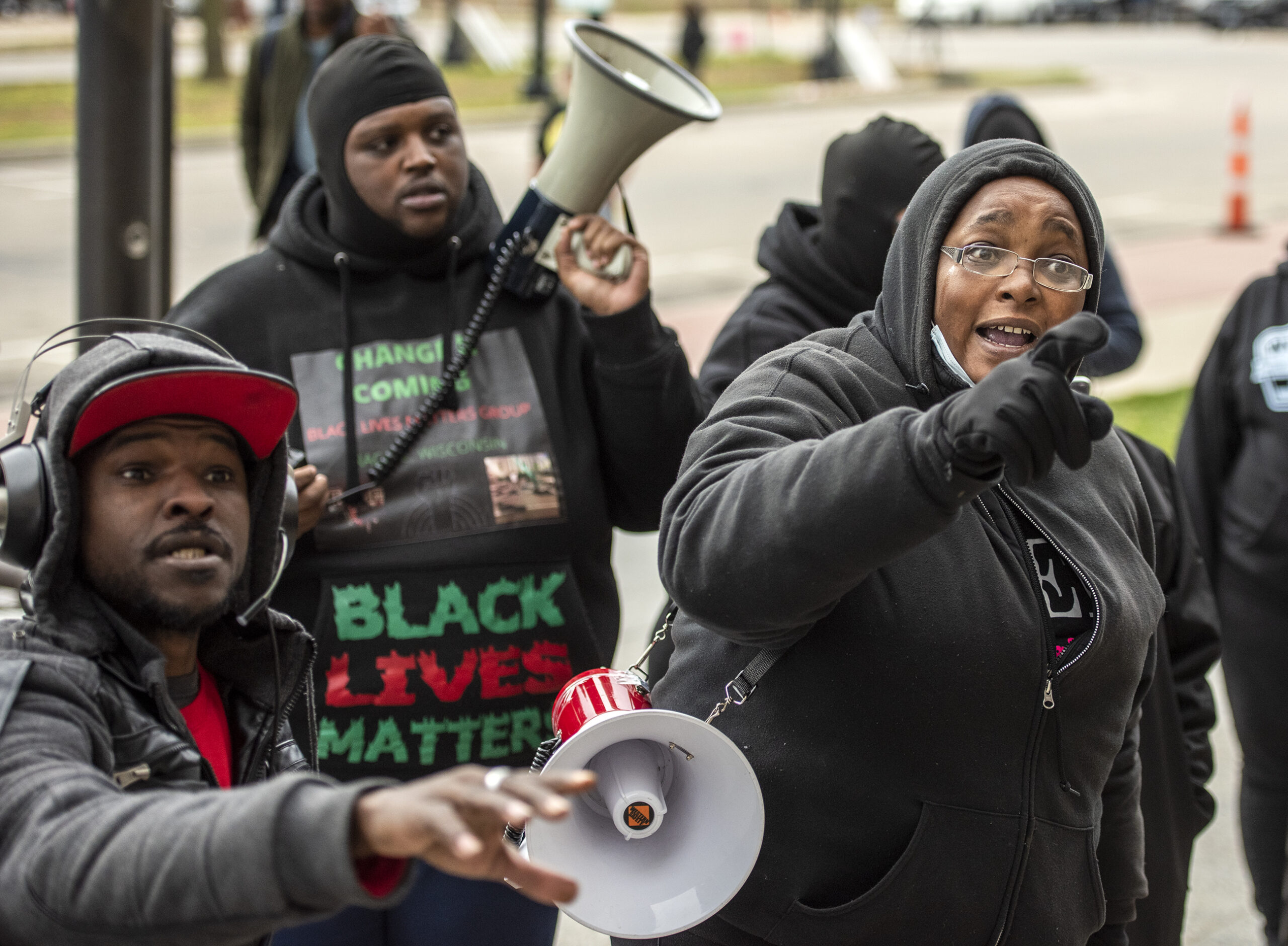 A woman points as she speaks passionately on the courthouse steps.