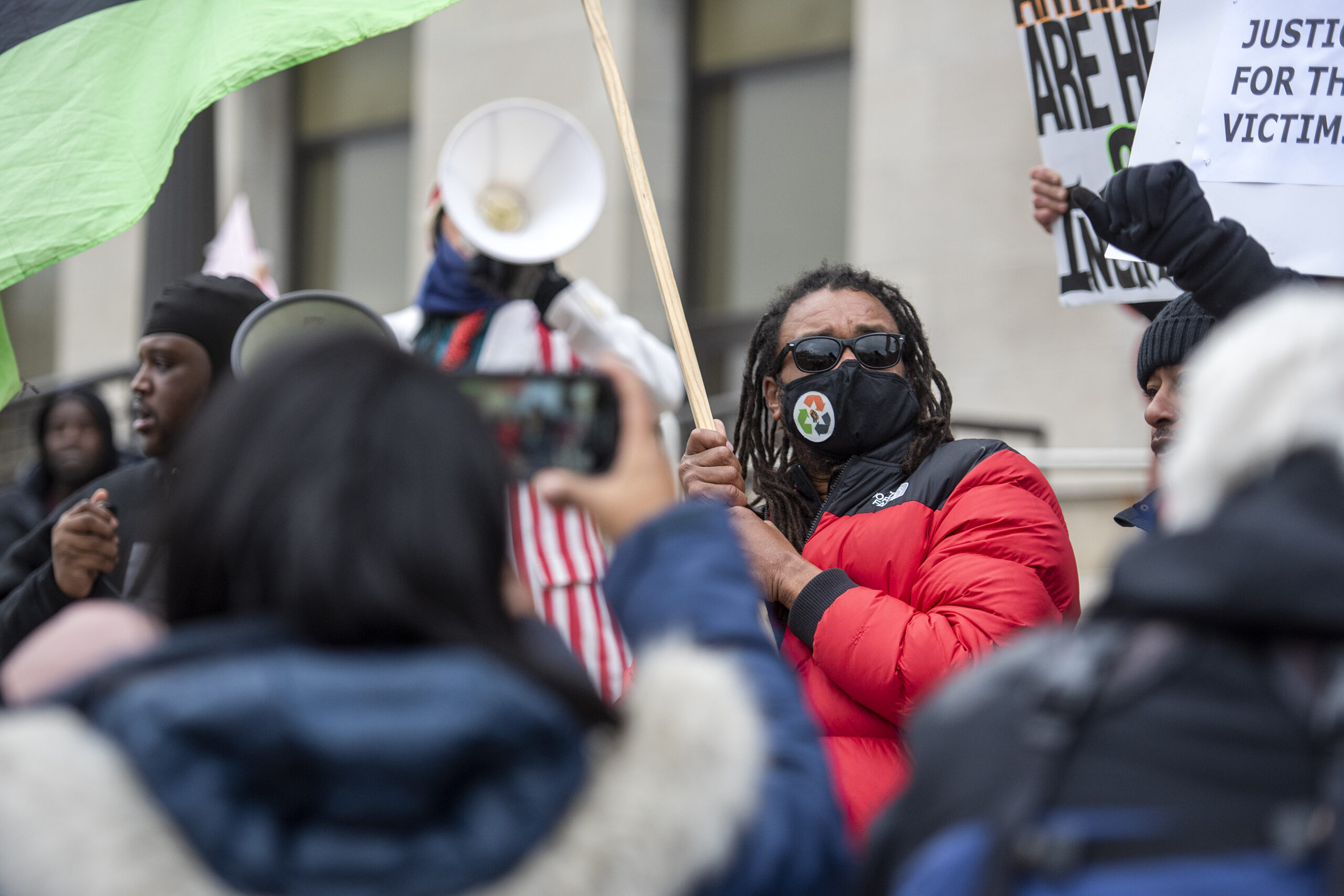 Justin Blake stands in a crowd as he holds a flag.