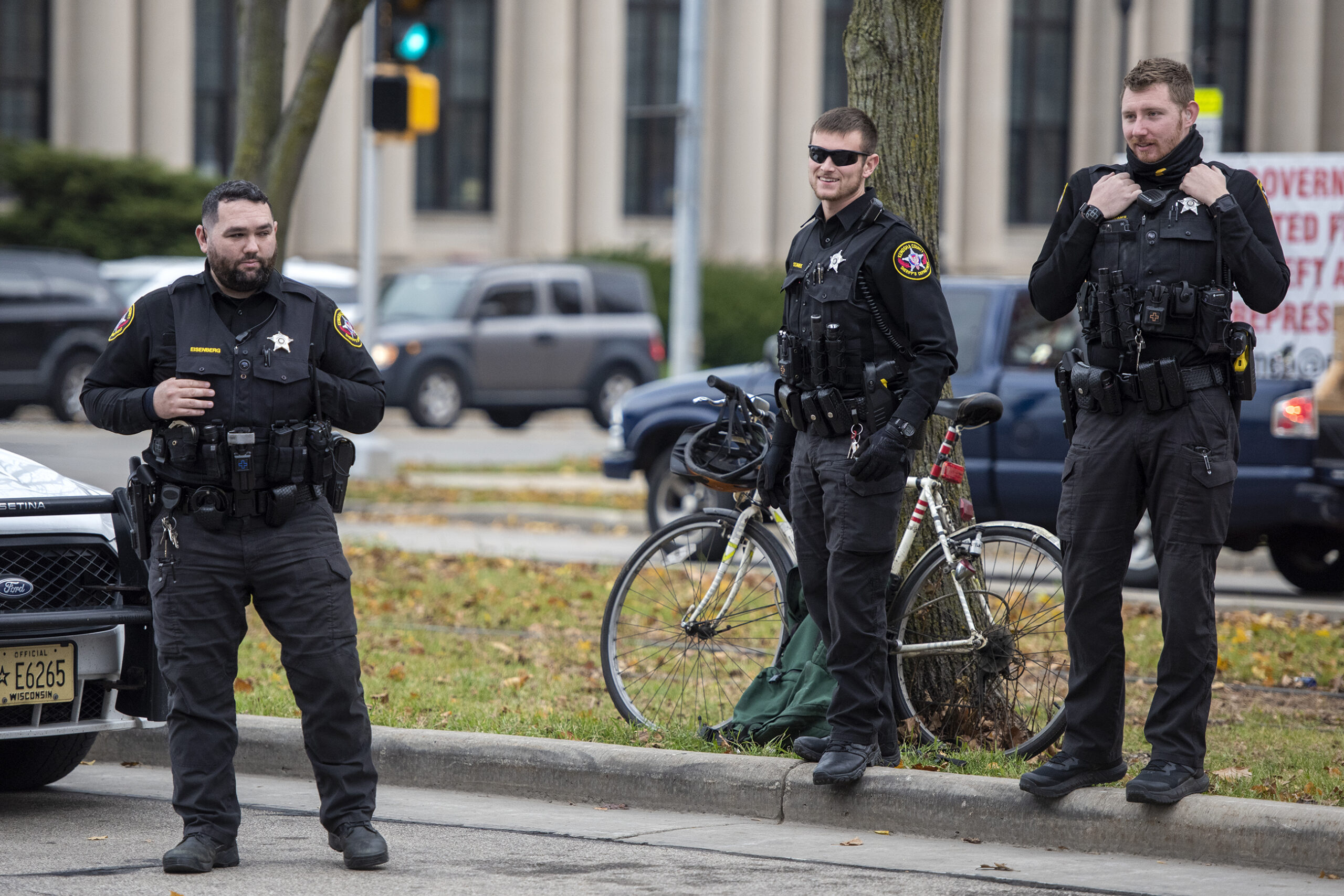 Three officers stand together.