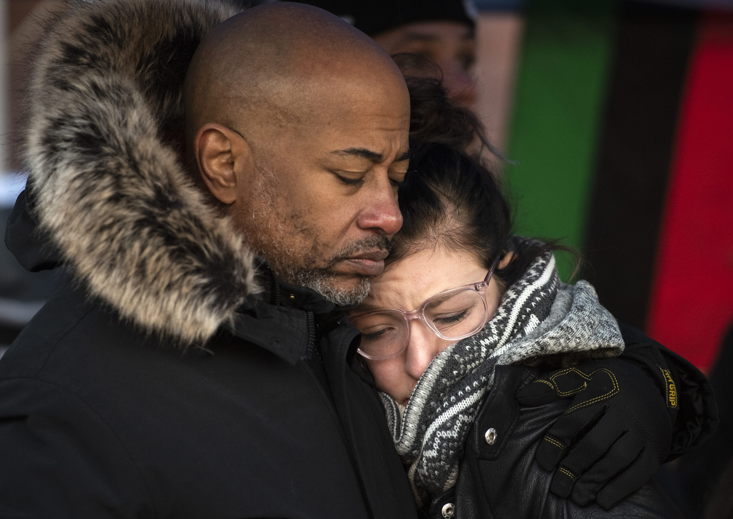 Two people hug in an emotional moment.