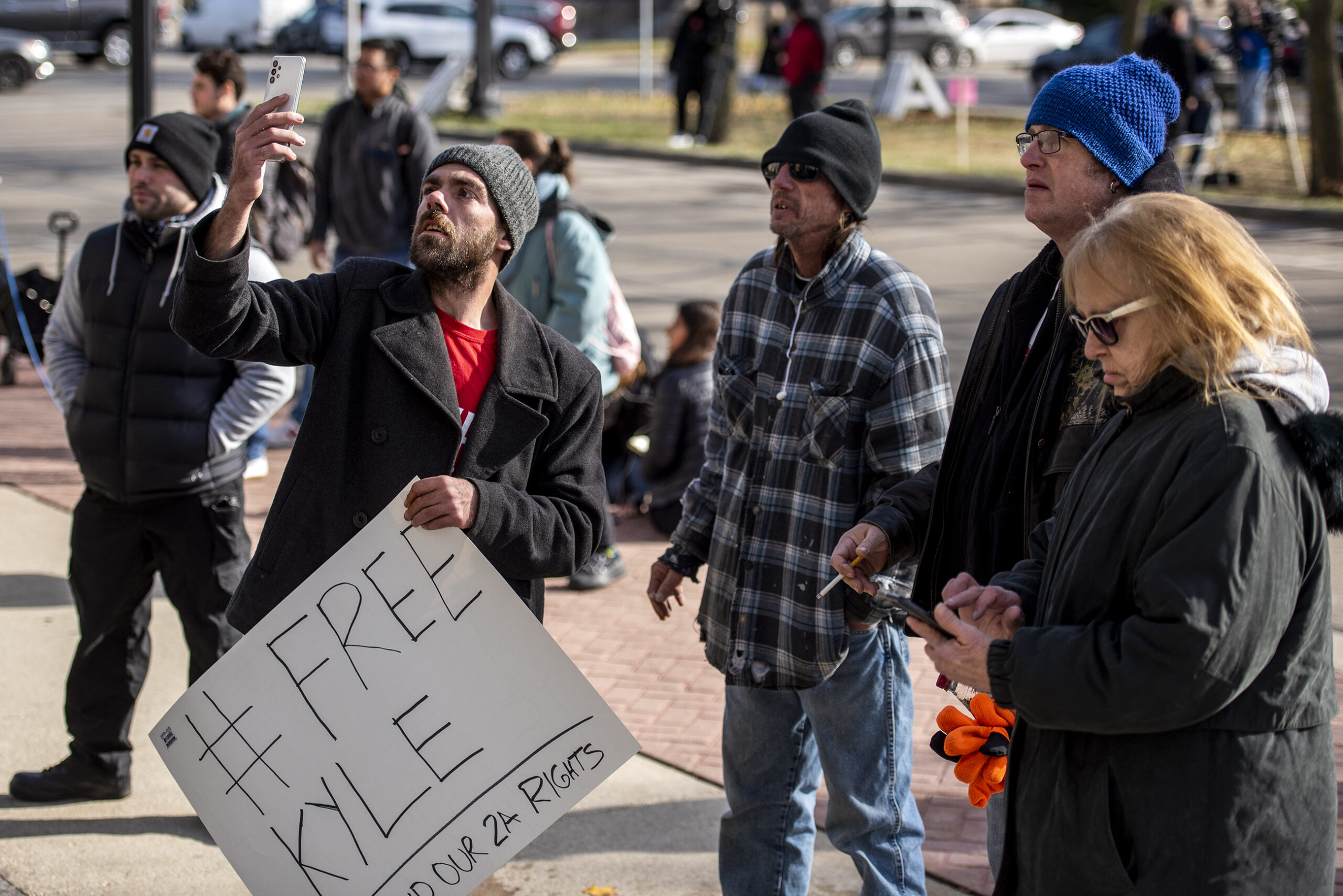 A man holds a sign that says 