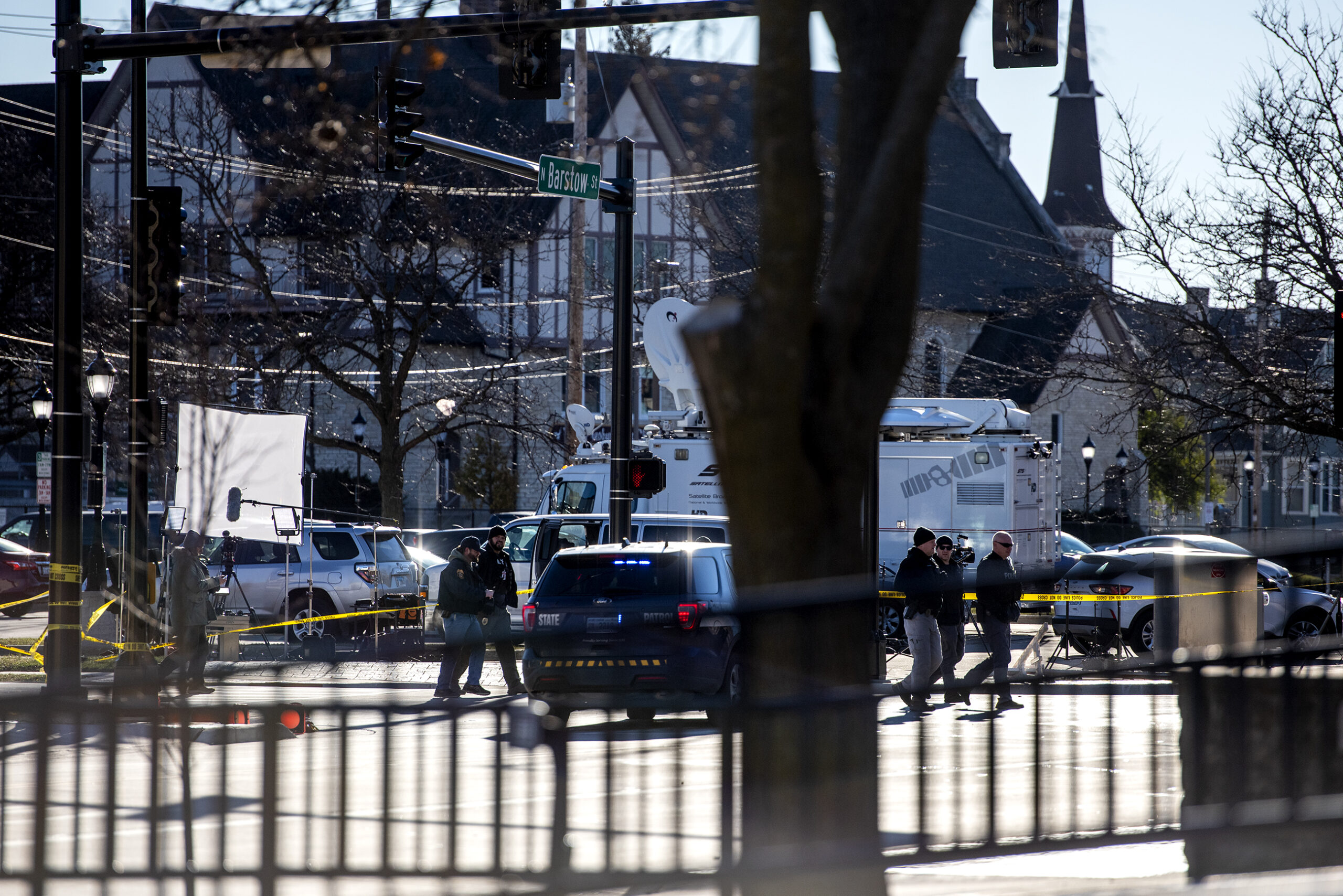 Five officers can be seen walking on the blocked off road.