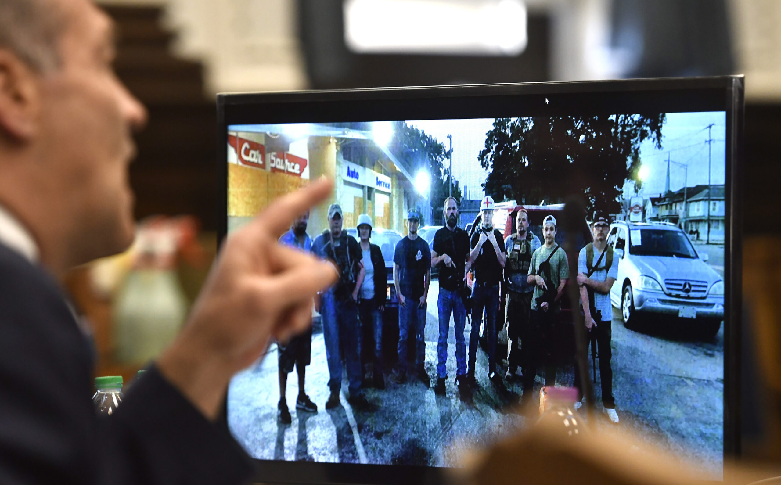 Mark Richards, lead attorney for Kyle Rittenhouse, shows a photograph with Kyle Rittenhouse