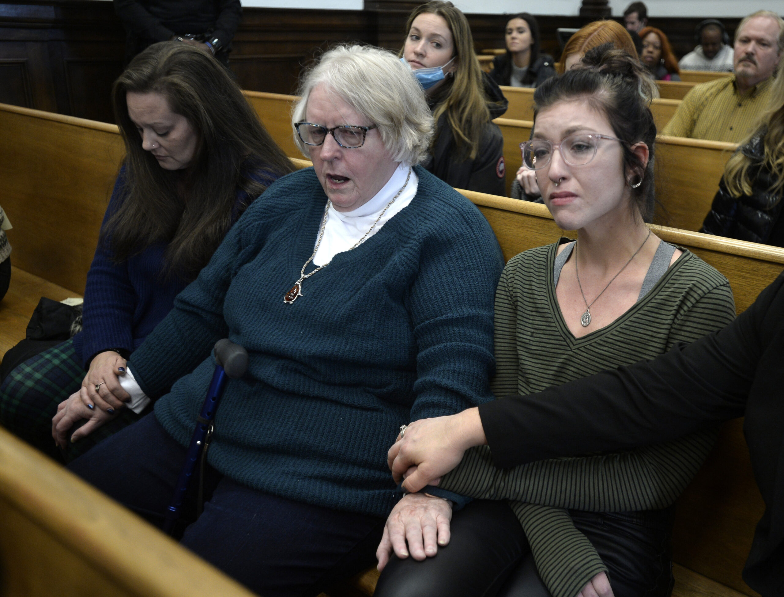 Kariann Swart, Susan Hughes and Hannah Gittings listen as Kyle Rittenhouse is found not guilty