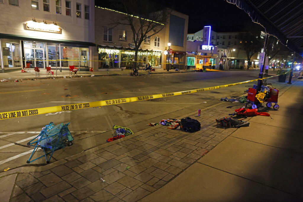 Police tape cordons off a street in Waukesha, Wis., after a vehicle plowed into a Christmas parade hitting more than 20 people.
