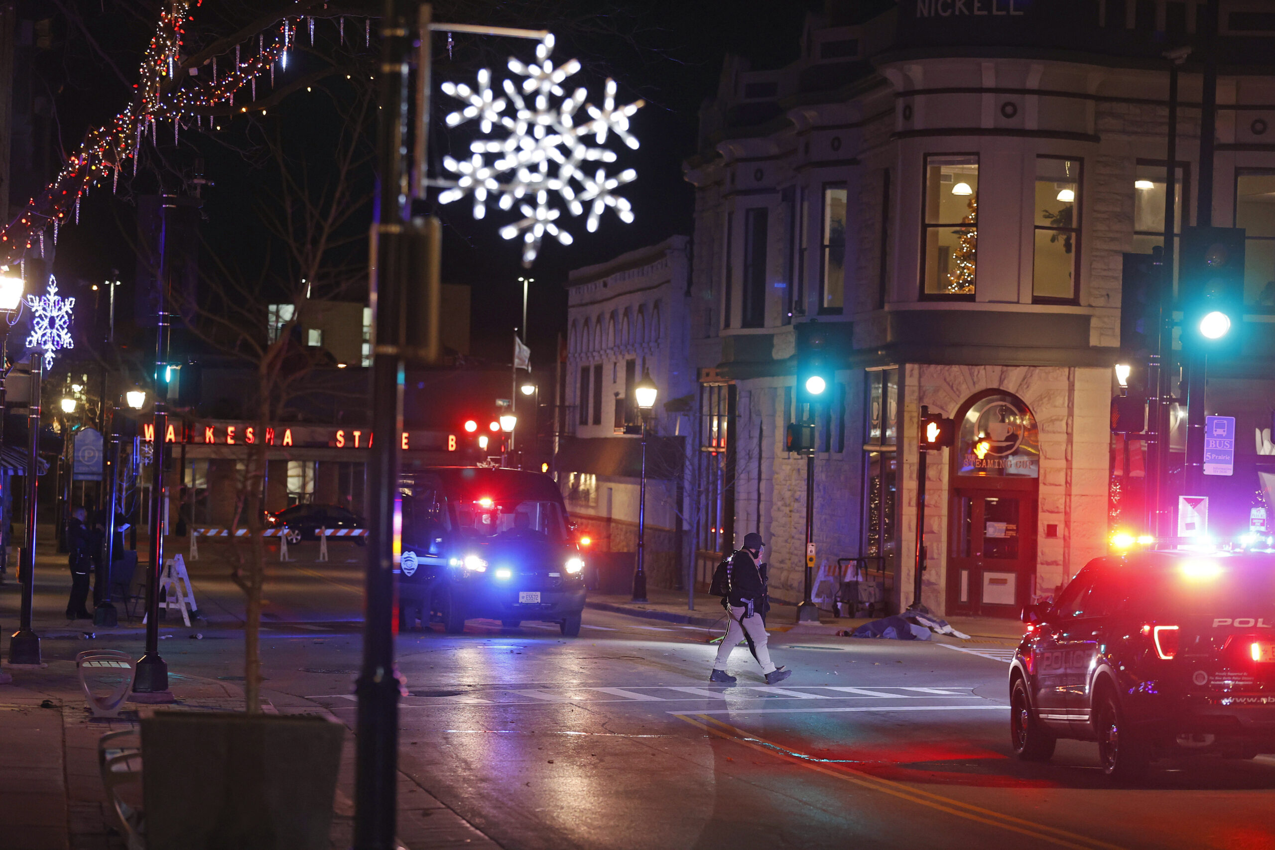 Police canvass the streets in downtown Waukesha after a vehicle plowed into a Christmas parade