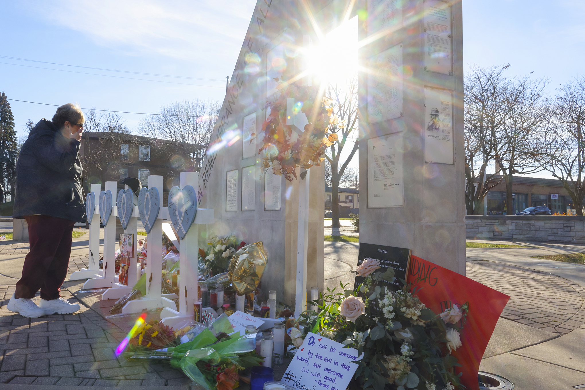 A person cries at a memorial in Waukesha, Wis.