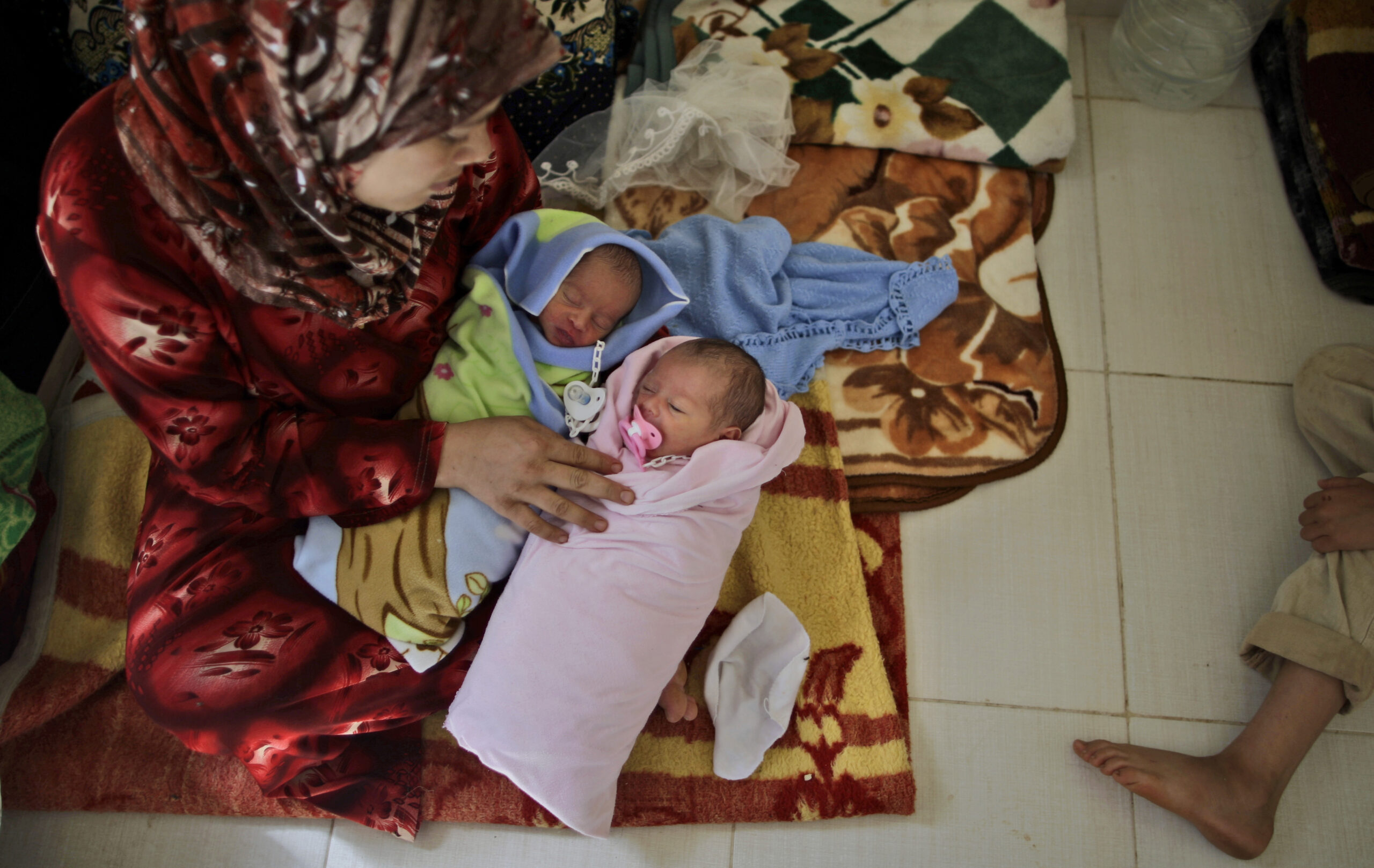 Fatimah Abdullah, 29, sits next to her 4-day-old twins