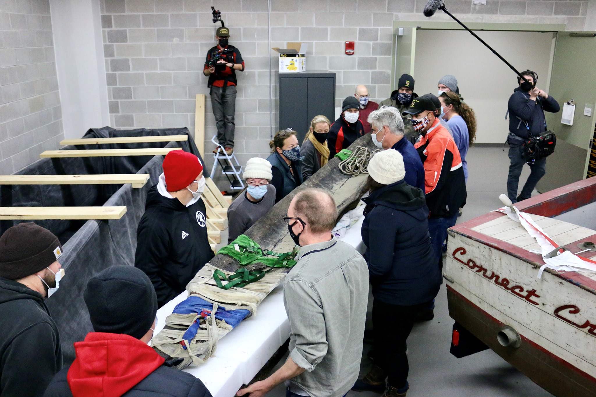 A 1,200-year-old canoe found in and recovered from Lake Mendota is transferred into a preservation vat