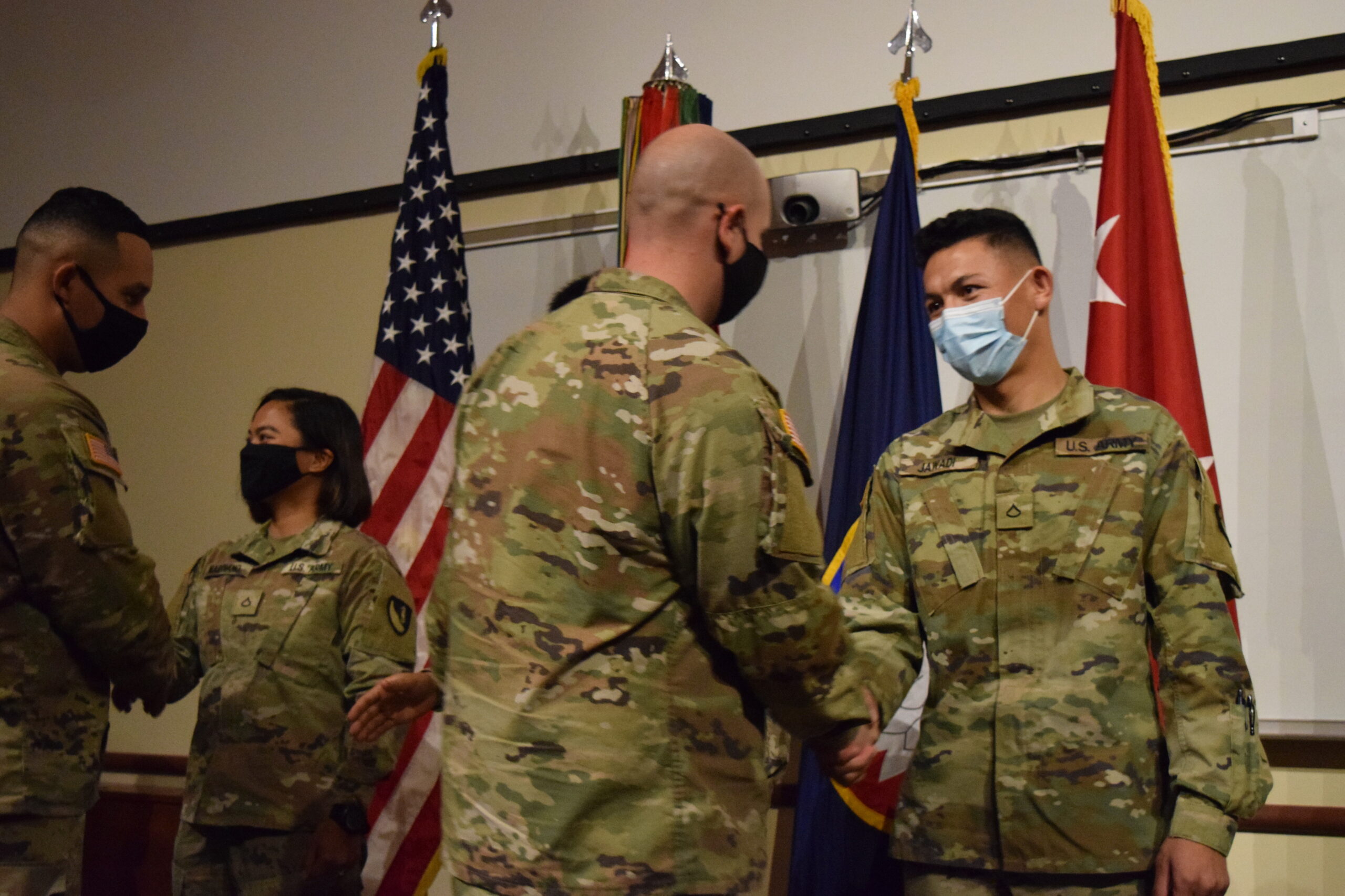 New U.S. citizens are congratulated by fellow soldiers