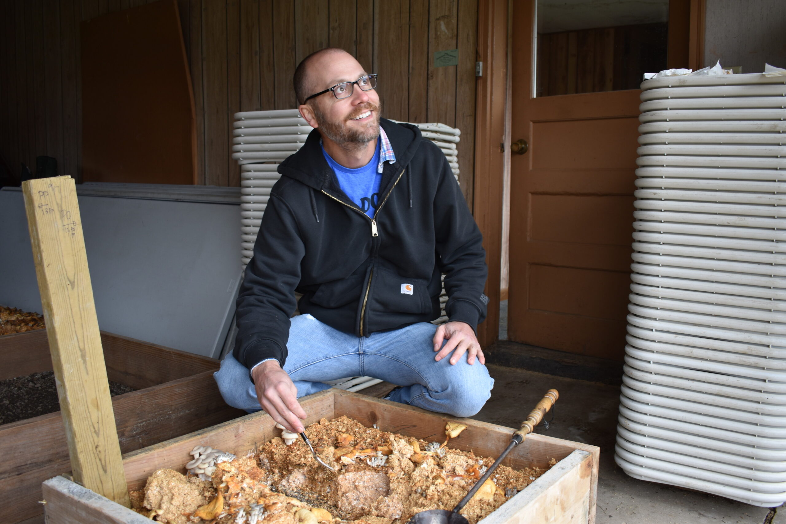 Mushroom farmer Jerome Segura prepares to take a soil sample at the mycoremediation site at the Marathon County landfill