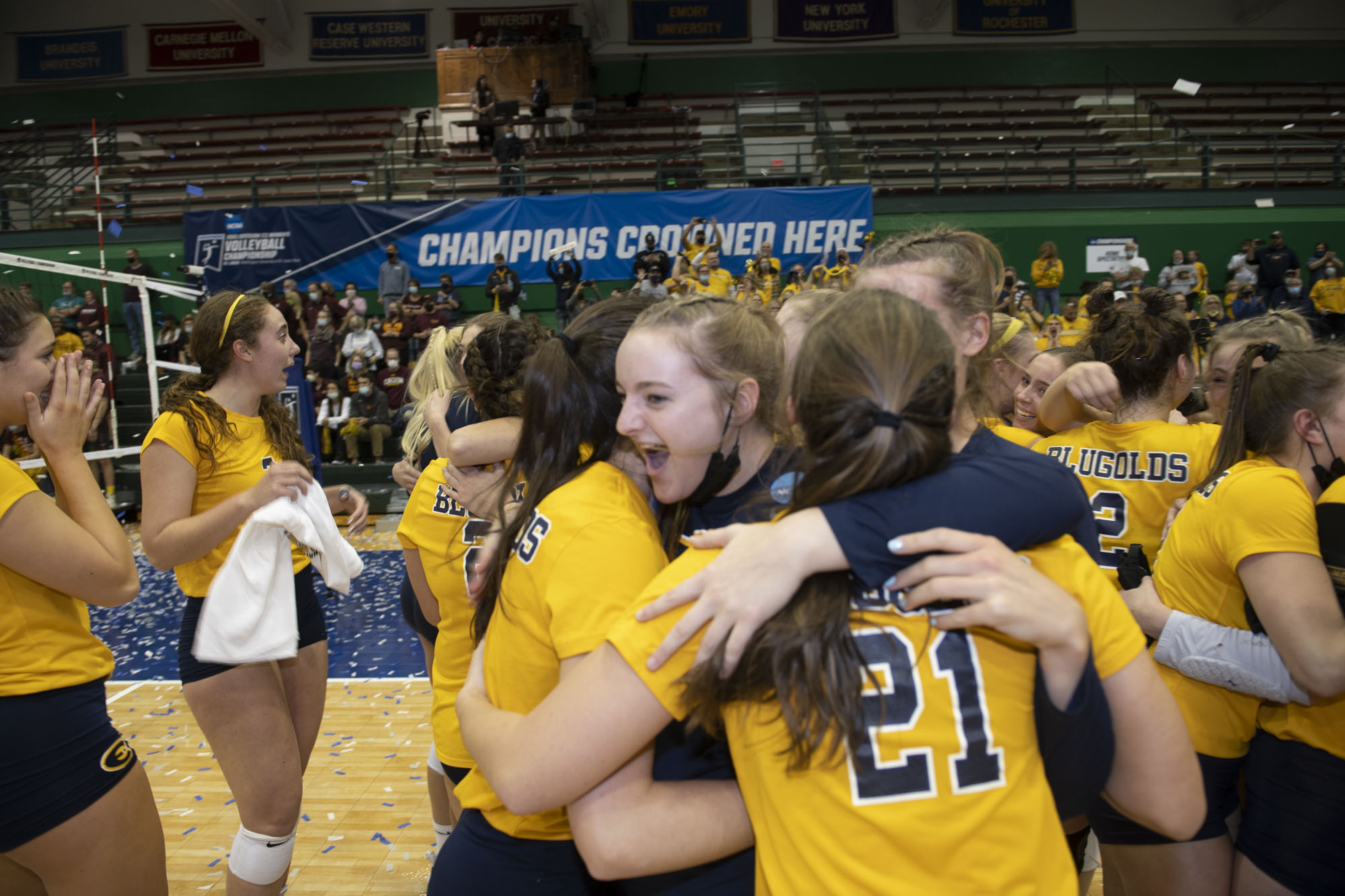 UW-Eay Claire volleyball team members hug after winning the Division III national championship