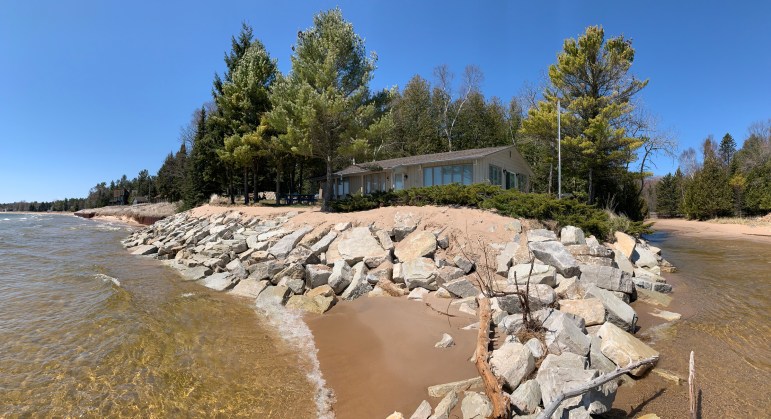 A home on the south side of Whitefish Bay Creek in Door County, Wis. with stones lining the shore