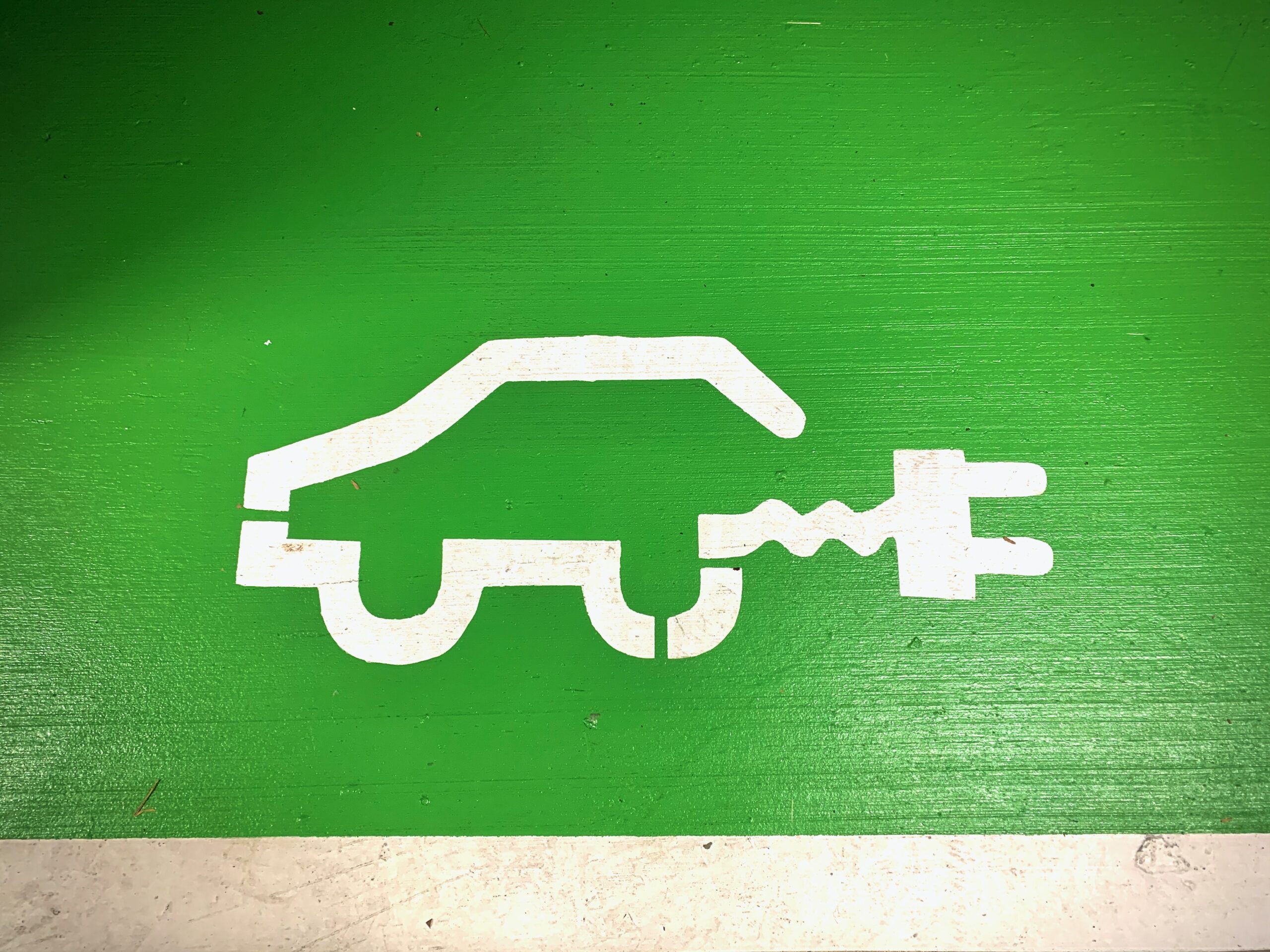 Drawing of a car with a plug on a garage wall