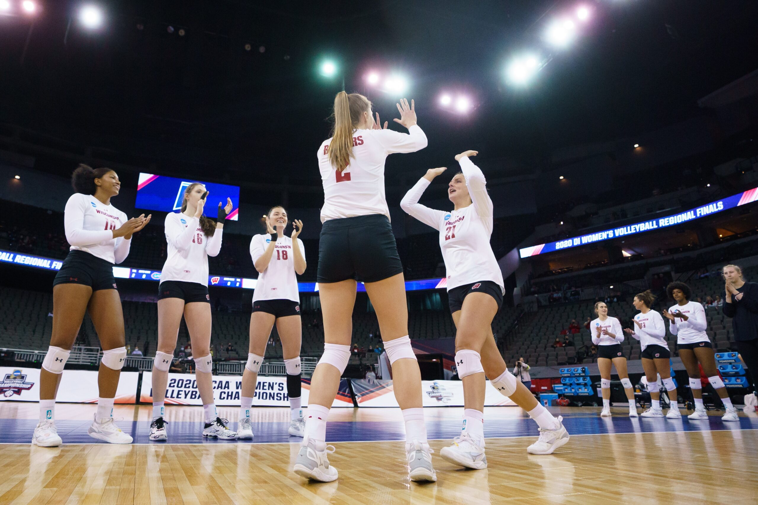 Wisconsin Badgers volleyball players take the court during the 2021 NCAA tournament