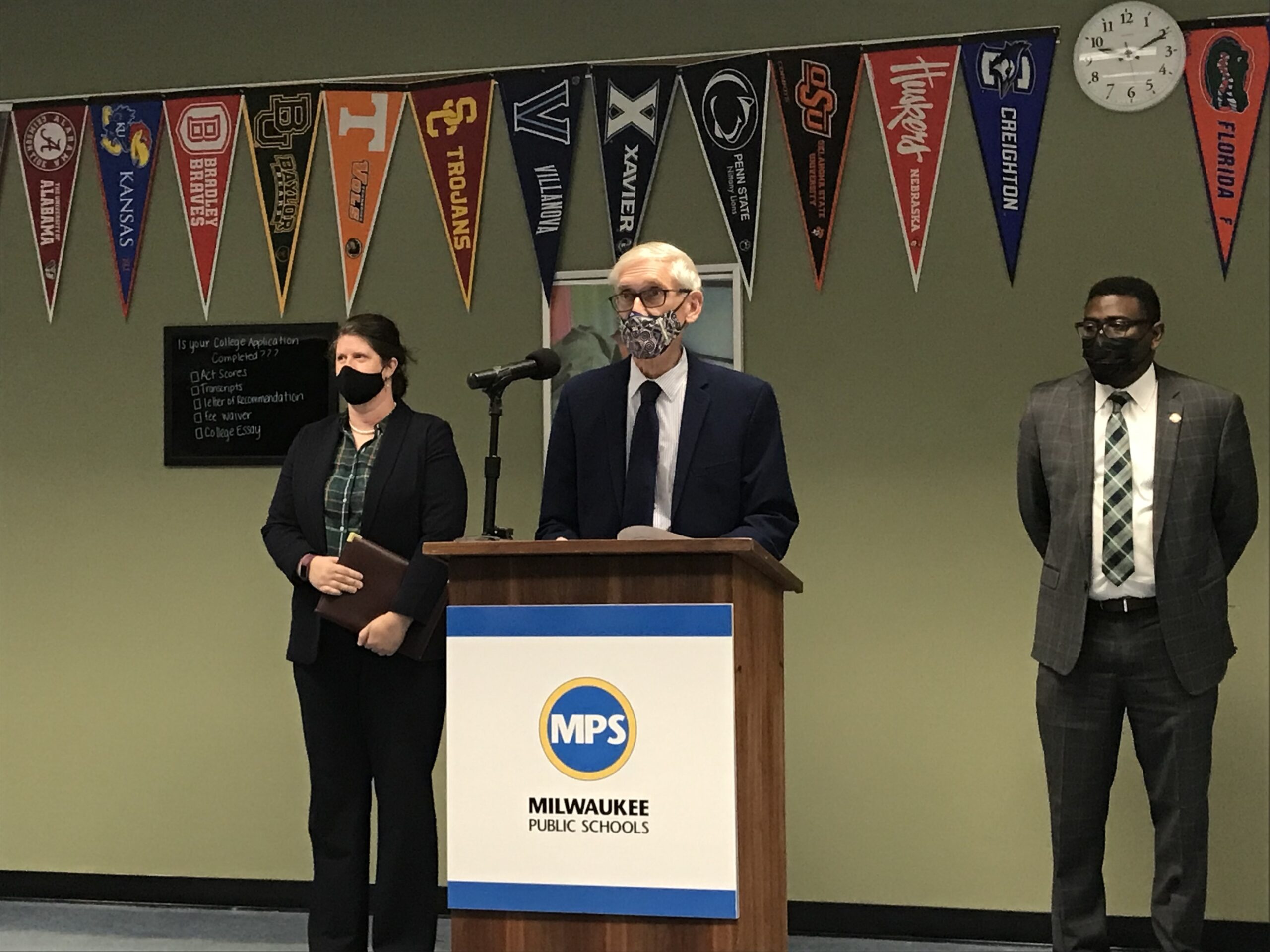 Governor Tony Evers stands with Milwaukee Public Schools superintendent Keith Posley and state schools superintendent Jill Underly as he announces $110 million in one-time funding for schools at North Division High School