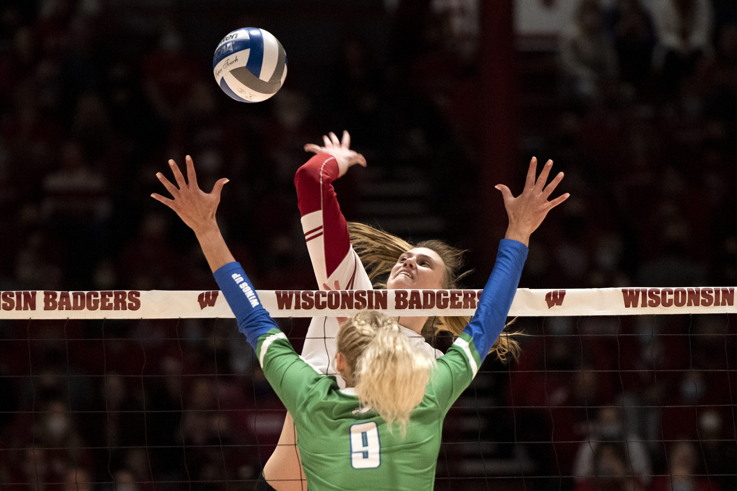 A Badgers player prepares to spike the ball.