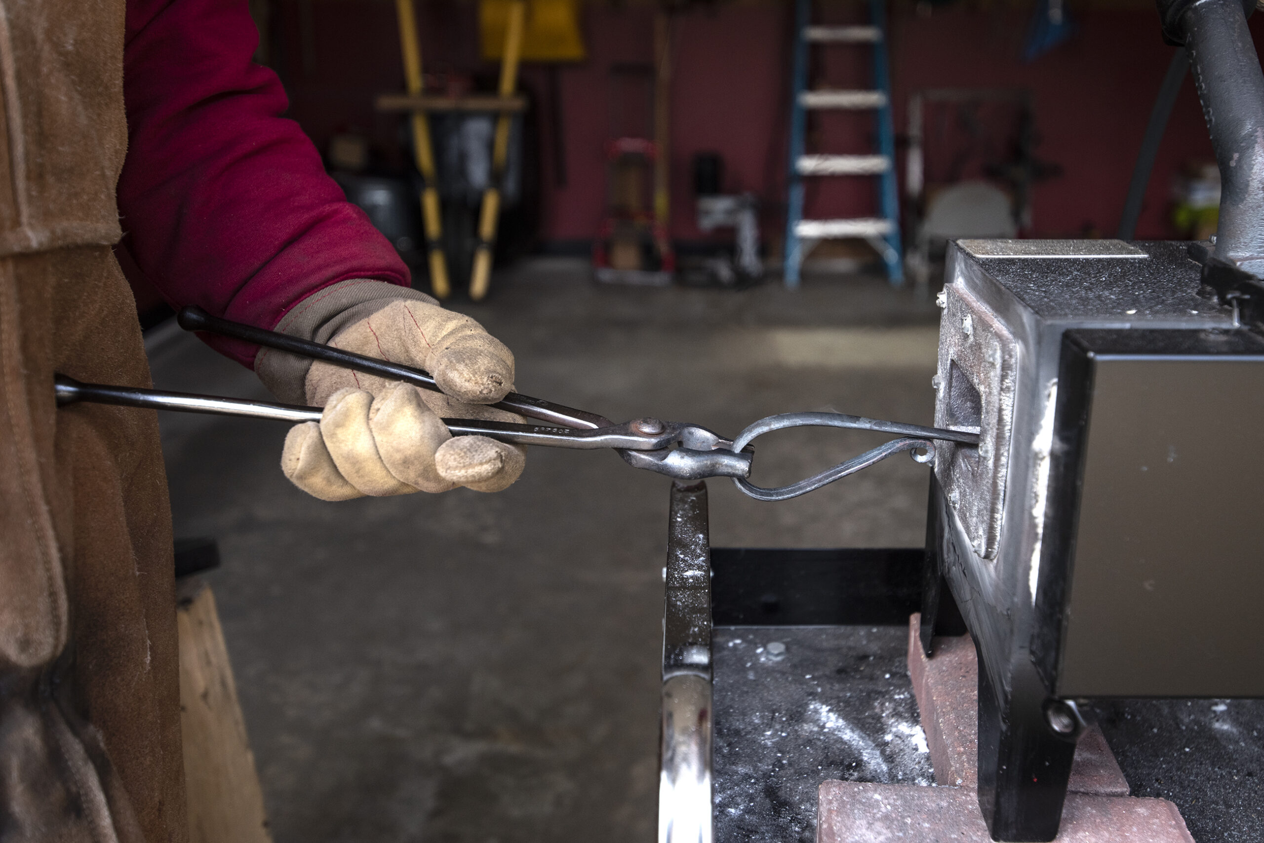 A small piece of metal is inserted into a forge.