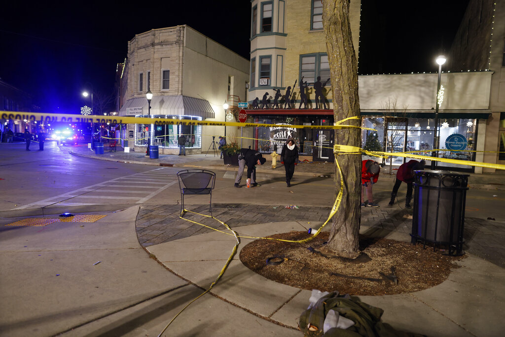 Police canvass the streets in downtown Waukesha, Wis., after a vehicle plowed into a Christmas parade hitting more than 20 people Sunday.
