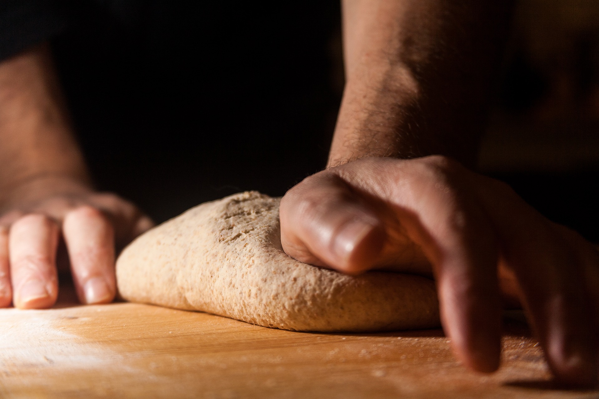 Hands kneading dough.