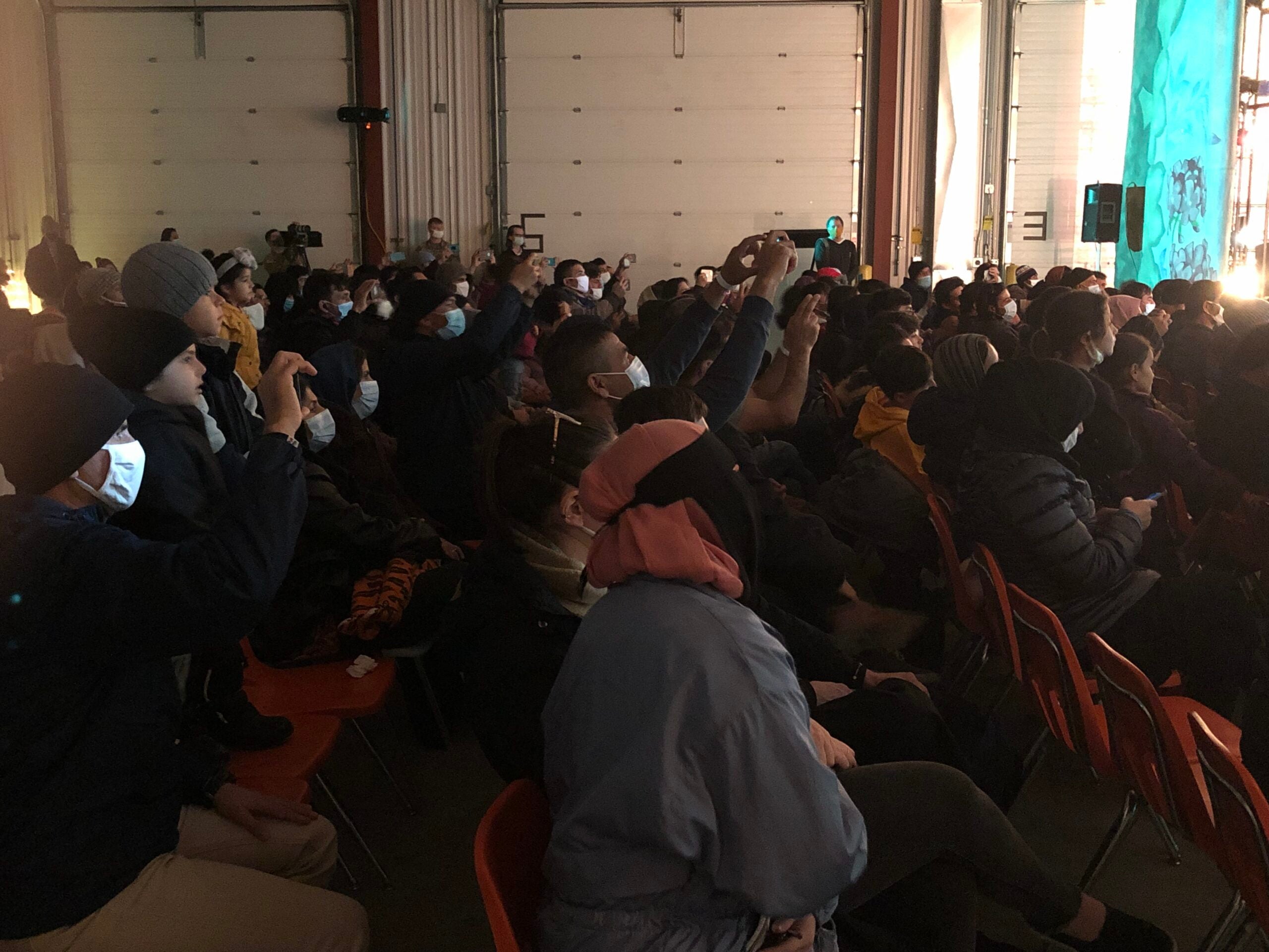 Refugee families watch