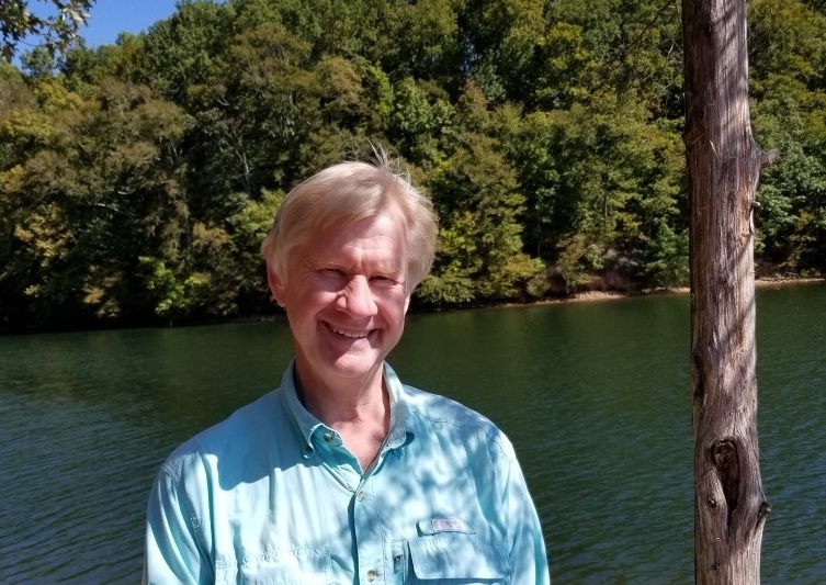 Jim Harju poses in front of a river