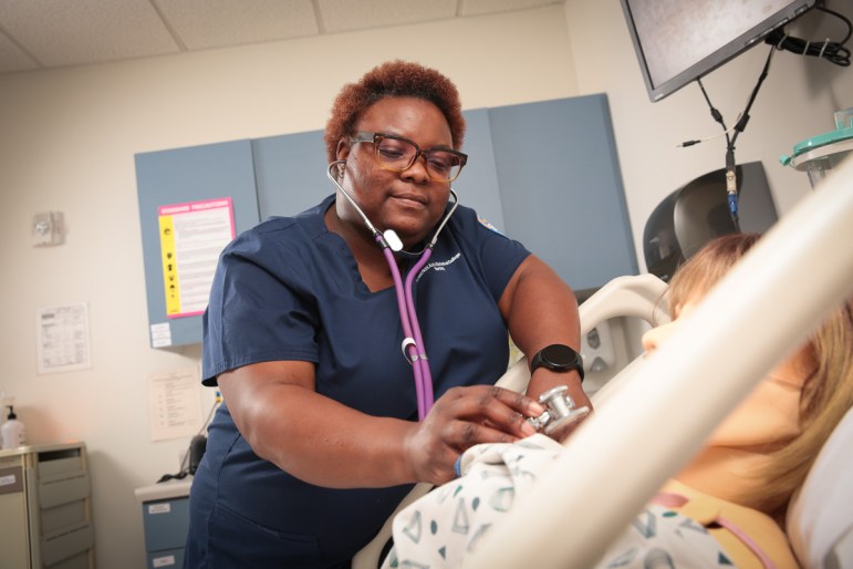 A nursing student works in a simulation lab at Milwaukee Area Technical College