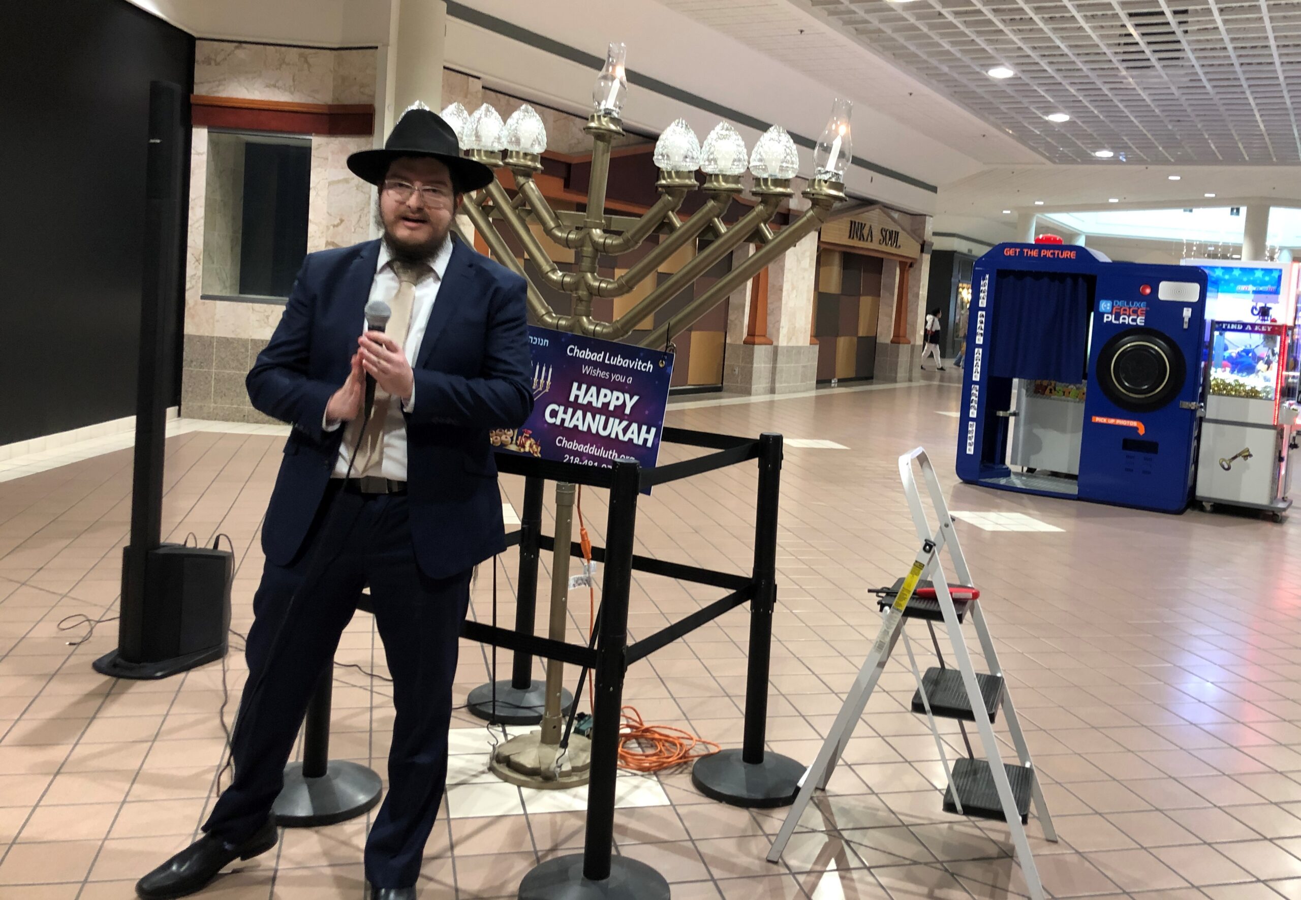 Rabbi Mendy Ross of Chabad of Duluth explains Hanukkah as he prepares to light the menorah at Miller Hill Mall in Duluth on the first night of the eight-day Jewish holiday on Sunday, Nov. 28. Photo by Robin Washington/WPR.