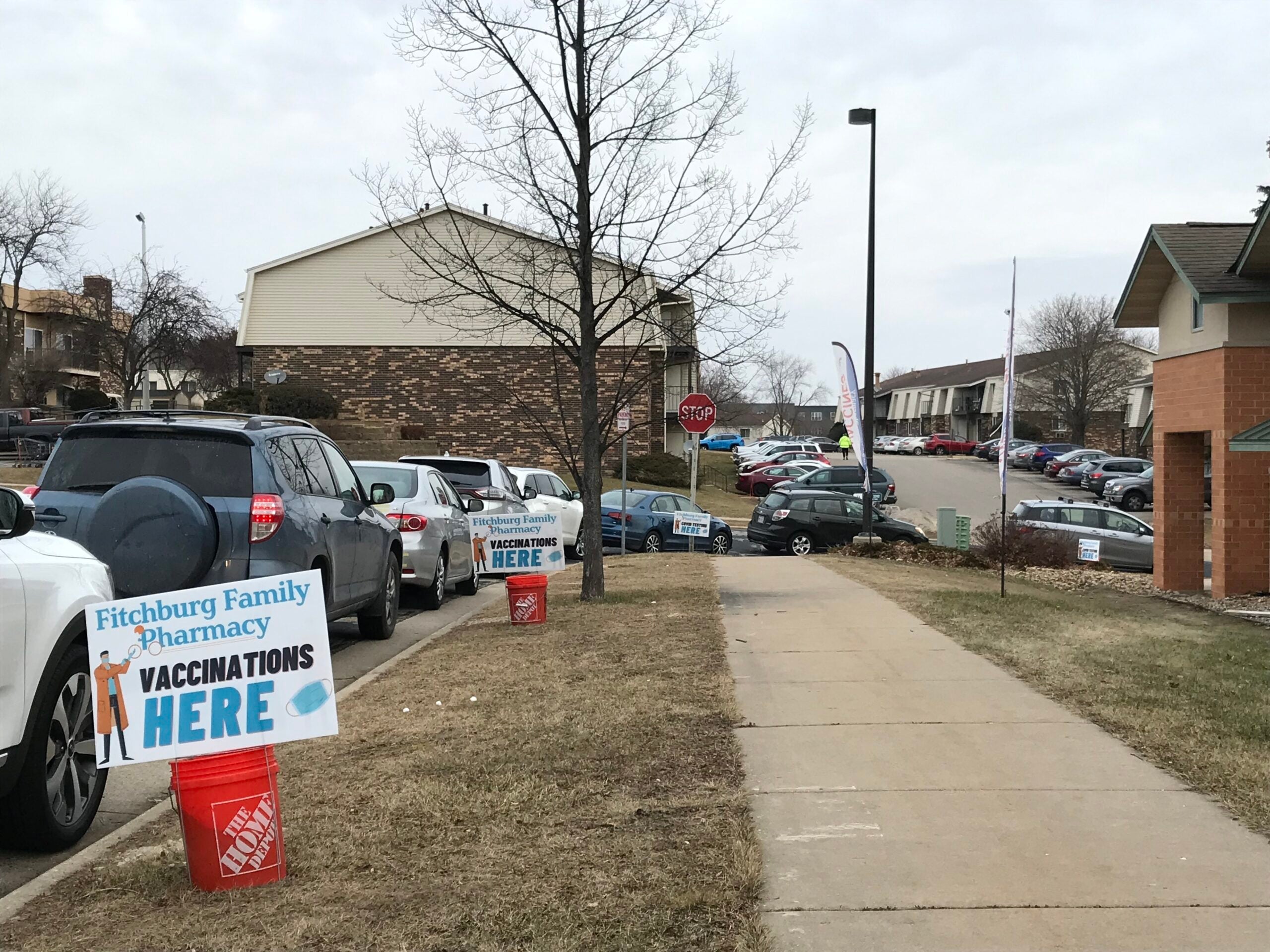 A line of cars sits outside Fitchburg Family Pharmacy for COVID-19 testing