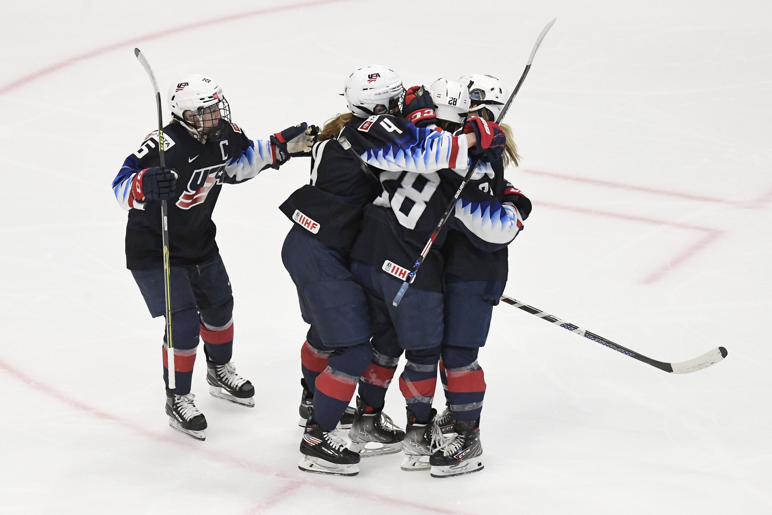U.S. Women's Hockey players celebrate with Amanda Kessel after her goal