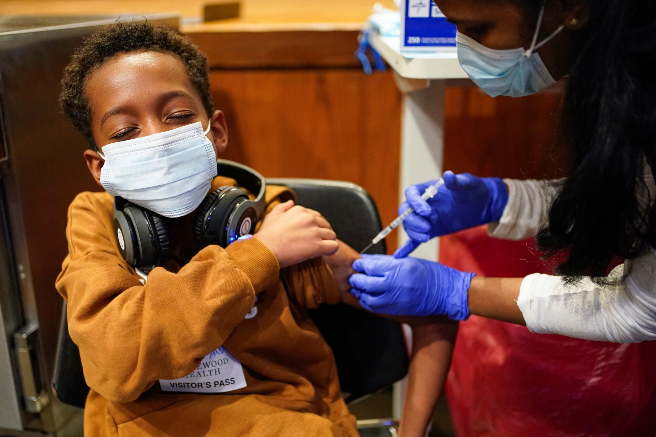 Cameron West, 9, receives a COVID-19 vaccination